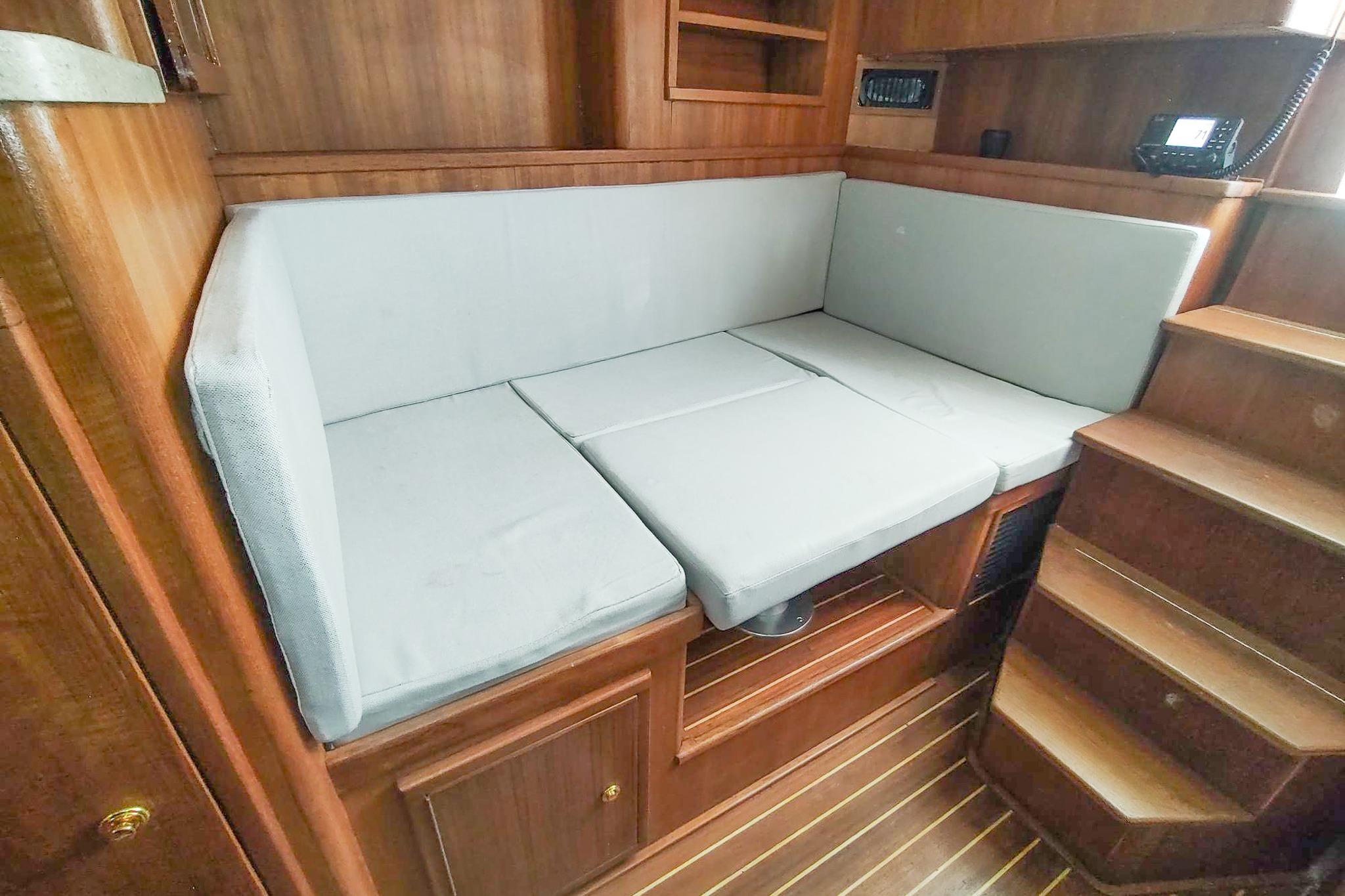 2017 Out Island SeaTek 36 Express interior with cushioned seating and wooden cabinetry.