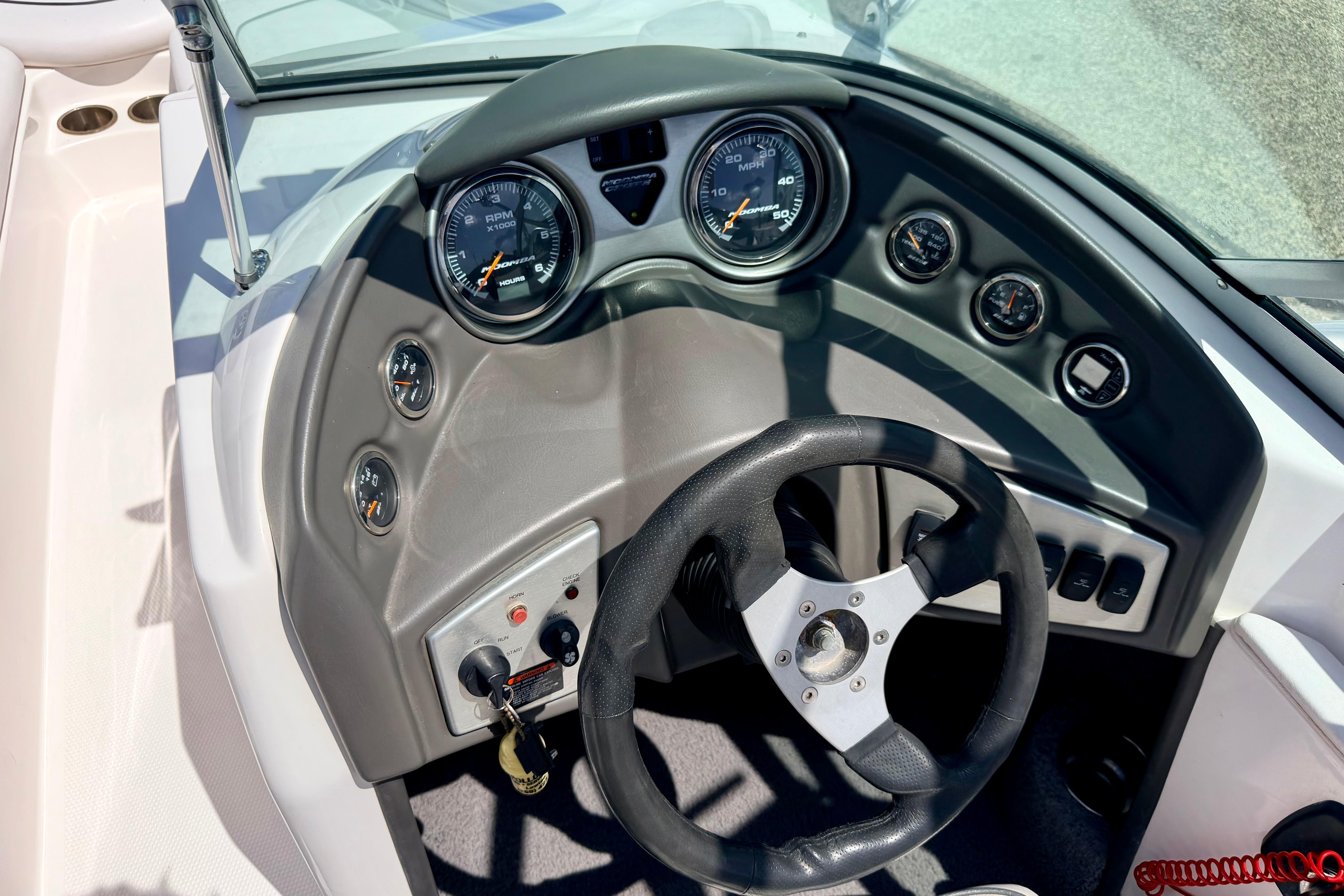 2008 Moomba Outback V dashboard with steering wheel and gauges.
