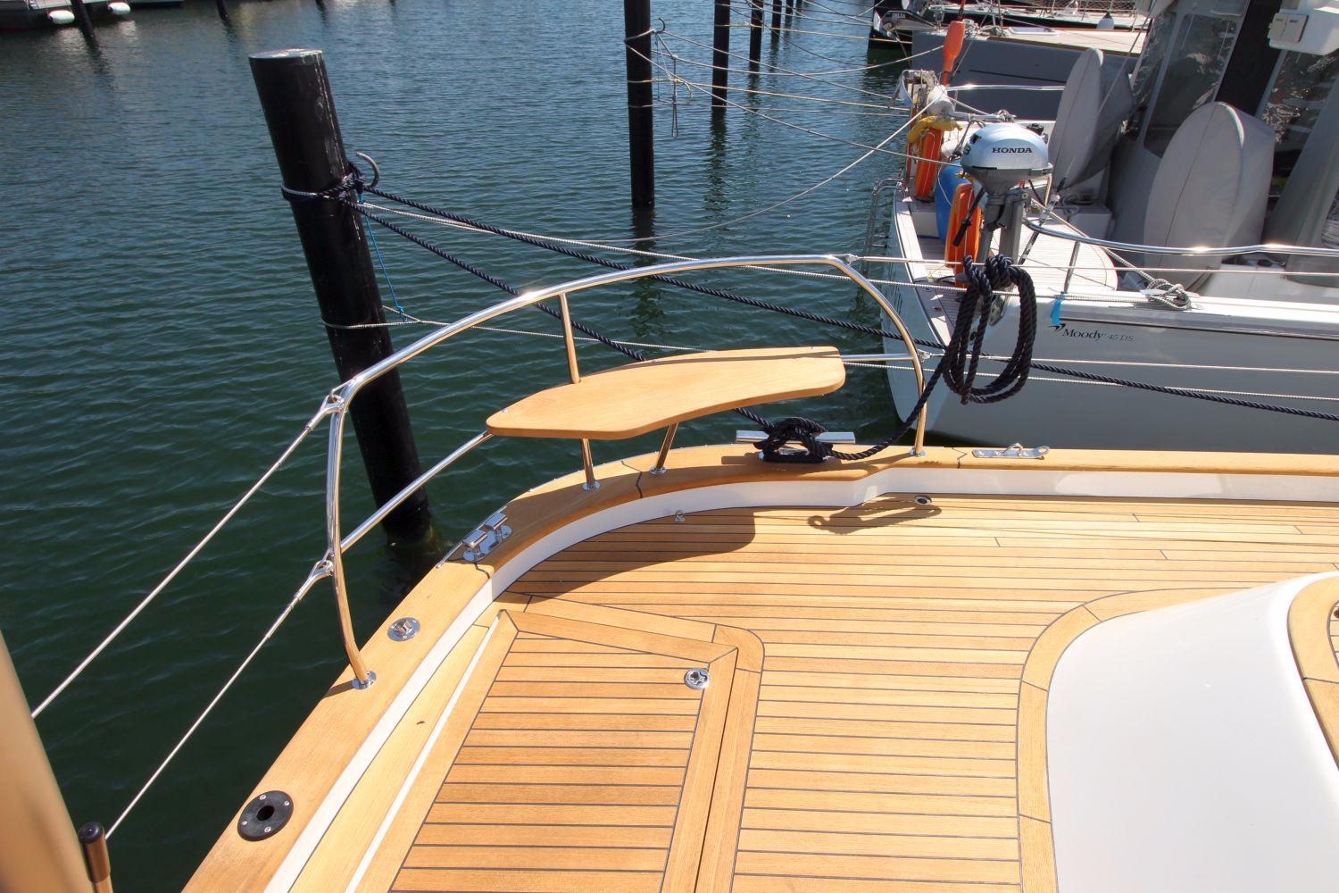 Deck of a 2018 Hallberg-Rassy 48 MkII sailboat in harbor.