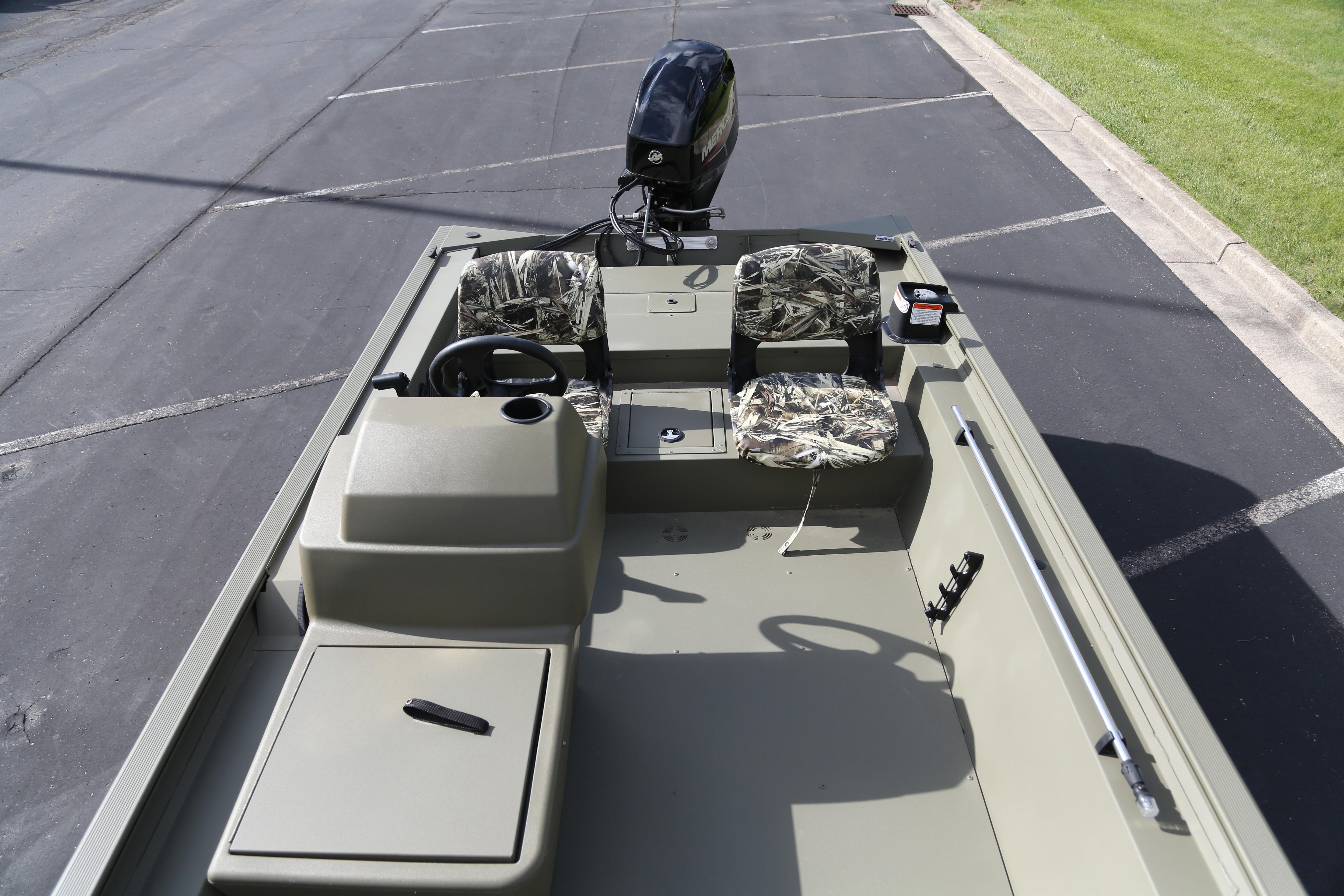 2026 Tracker Grizzly 1754 SC boat with camouflage seats and steering console.
