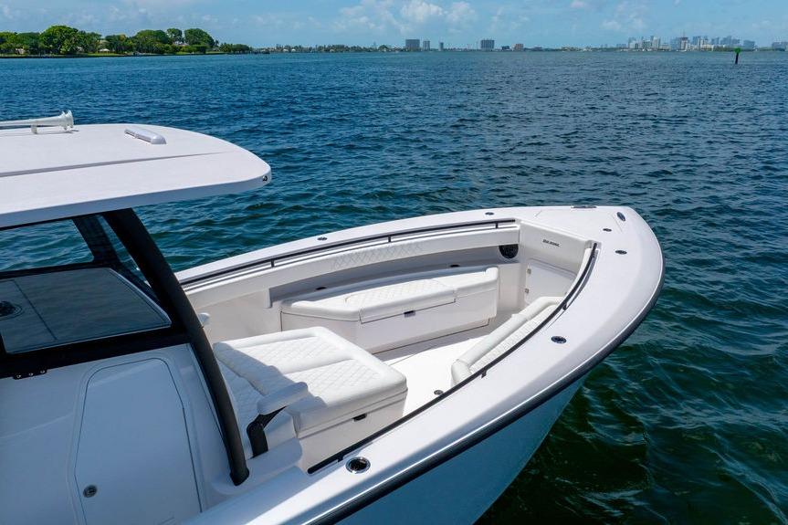 Modern 2027 Reef Runner 340 boat on calm blue waters, featuring sleek design and spacious seating.