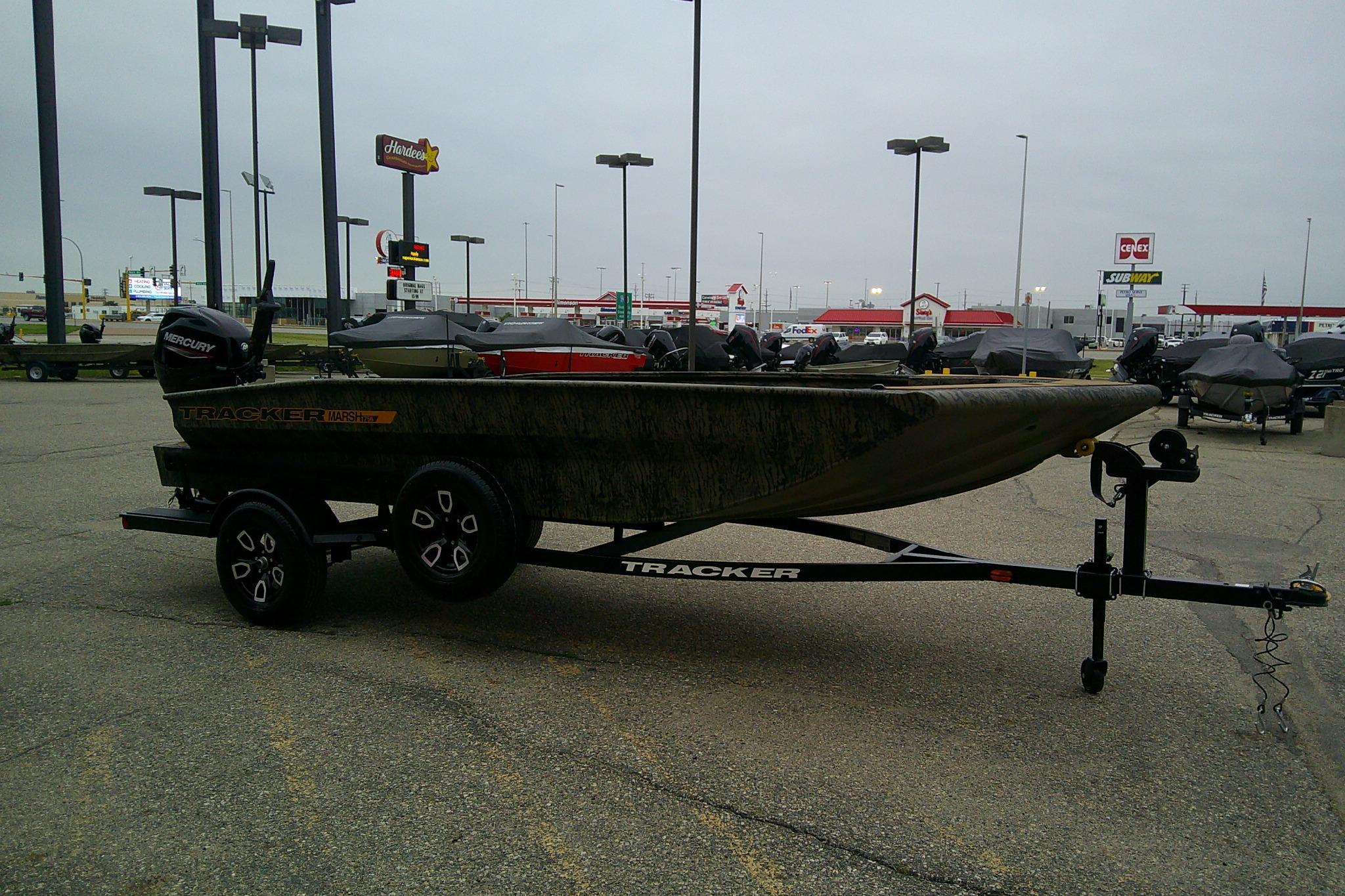 2026 Tracker Grizzly 1756 T Marsh boat on trailer in parking lot.