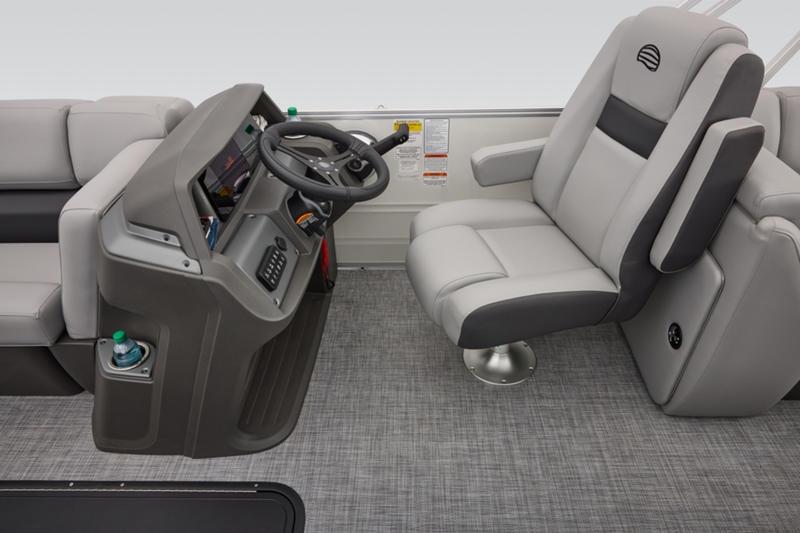 2026 Sun Tracker Party Barge 22 DLX interior with steering console and plush seating.
