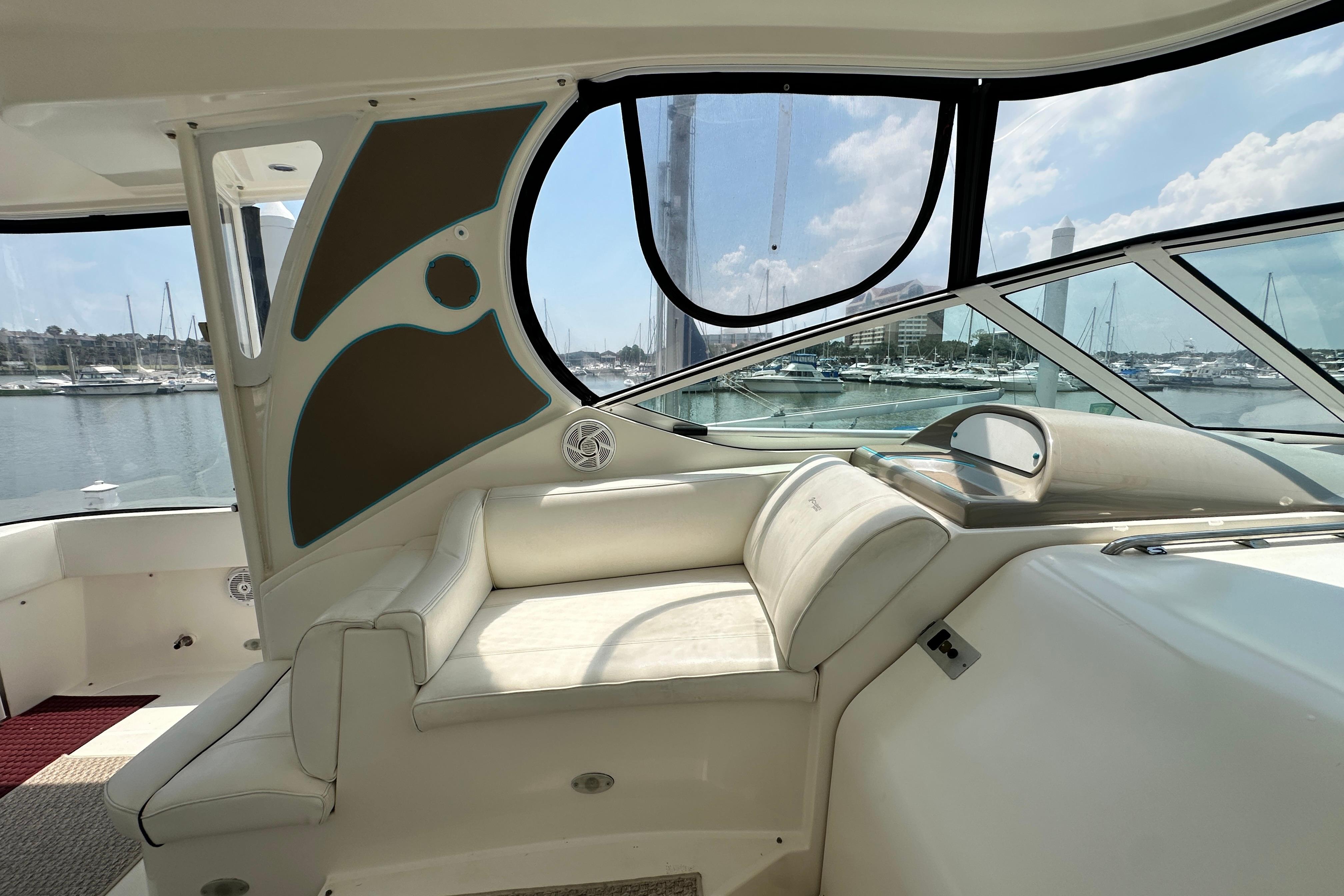 2004 Cruisers Yachts 405 Express Motoryacht interior with marina view through large windows.