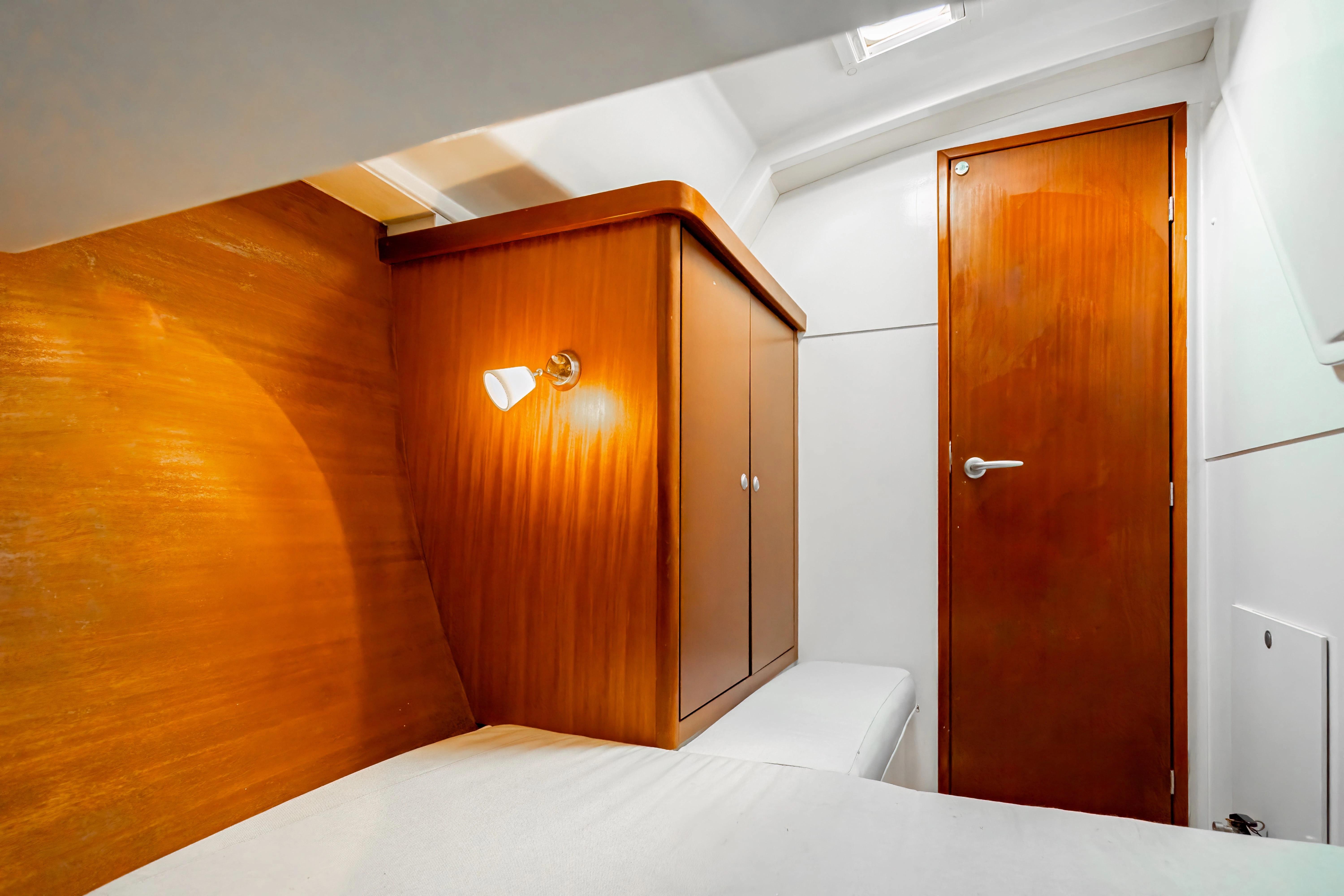 Interior cabin of 2011 Hanse 400 yacht with wooden cabinetry and door.