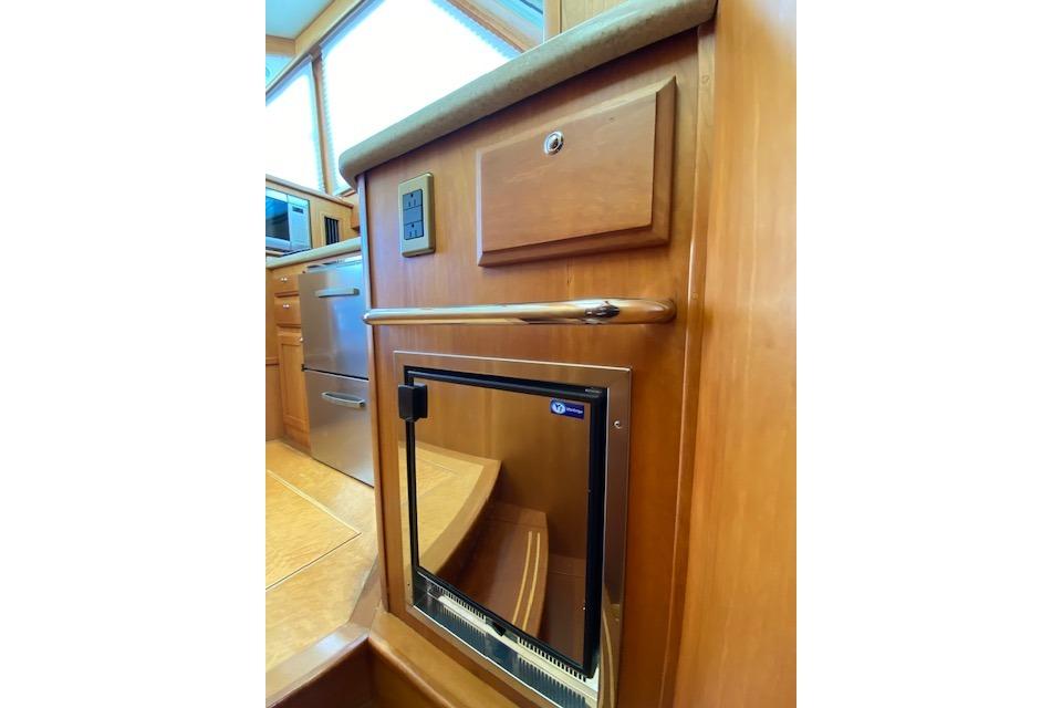 Interior of 2010 Sabre 38 Express yacht with wooden cabinetry and stainless steel appliances.