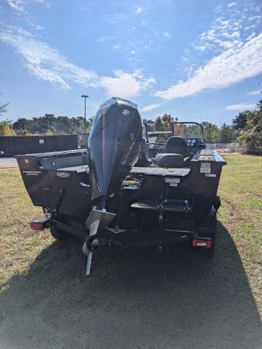 2025 Tracker Targa V-19 WT boat, rear view, parked on grass under a clear sky.