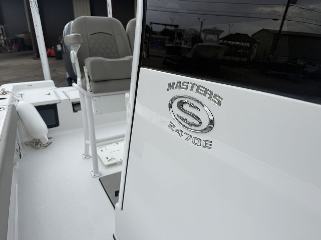 Close-up of the Sportsman Masters 247OE Bay Boat with gray seats and shiny logo.