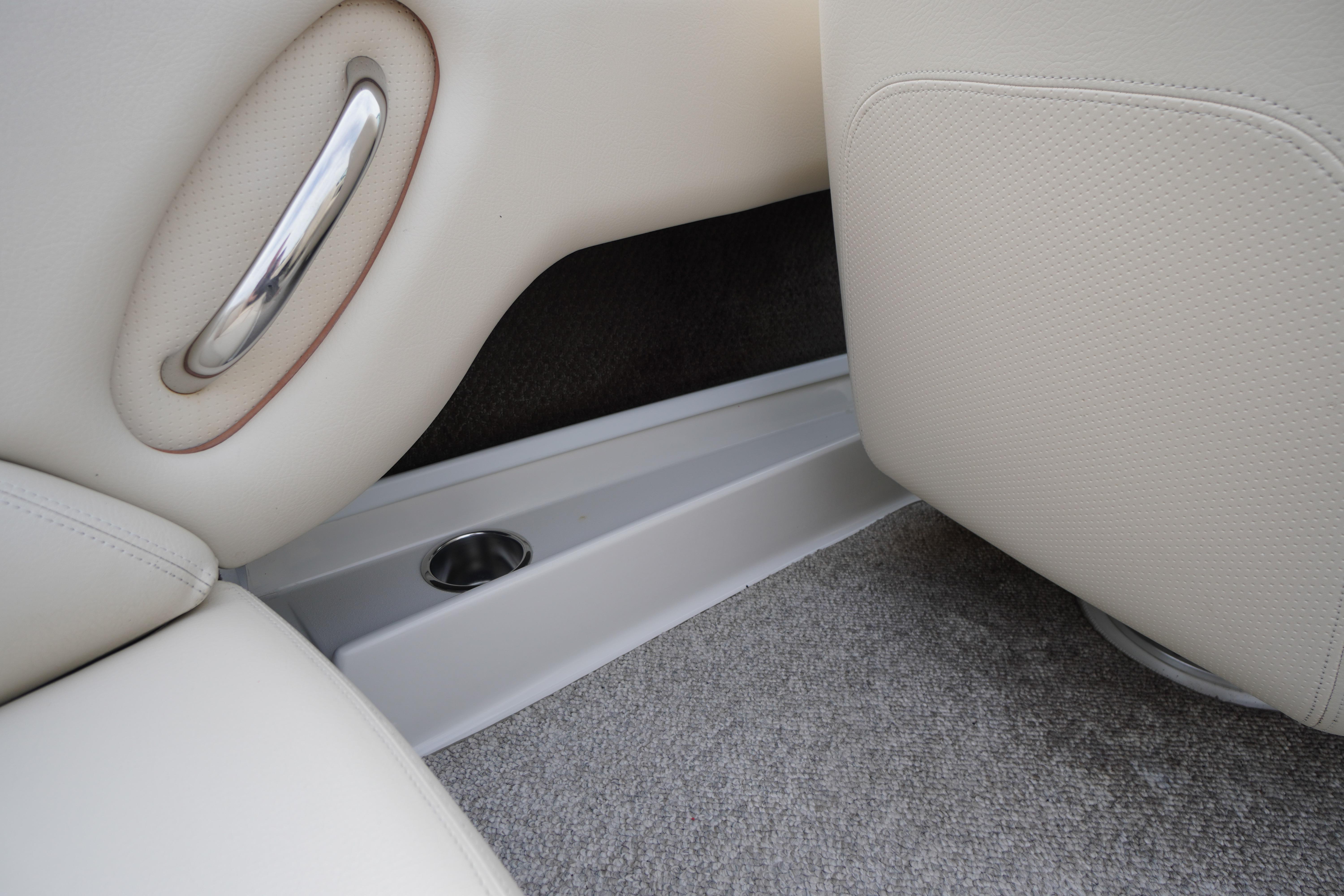 Interior of 2005 Chris Craft Speedster Heritage with beige upholstery and metal accents.