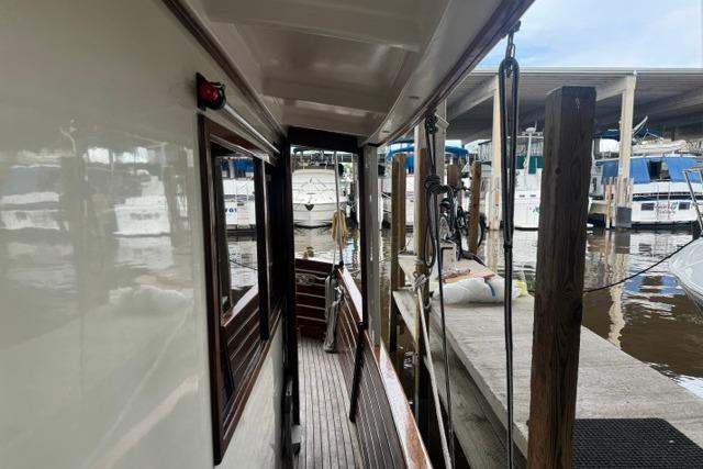 Side deck view of 1986 Kadey-Krogen 42 yacht docked at marina.