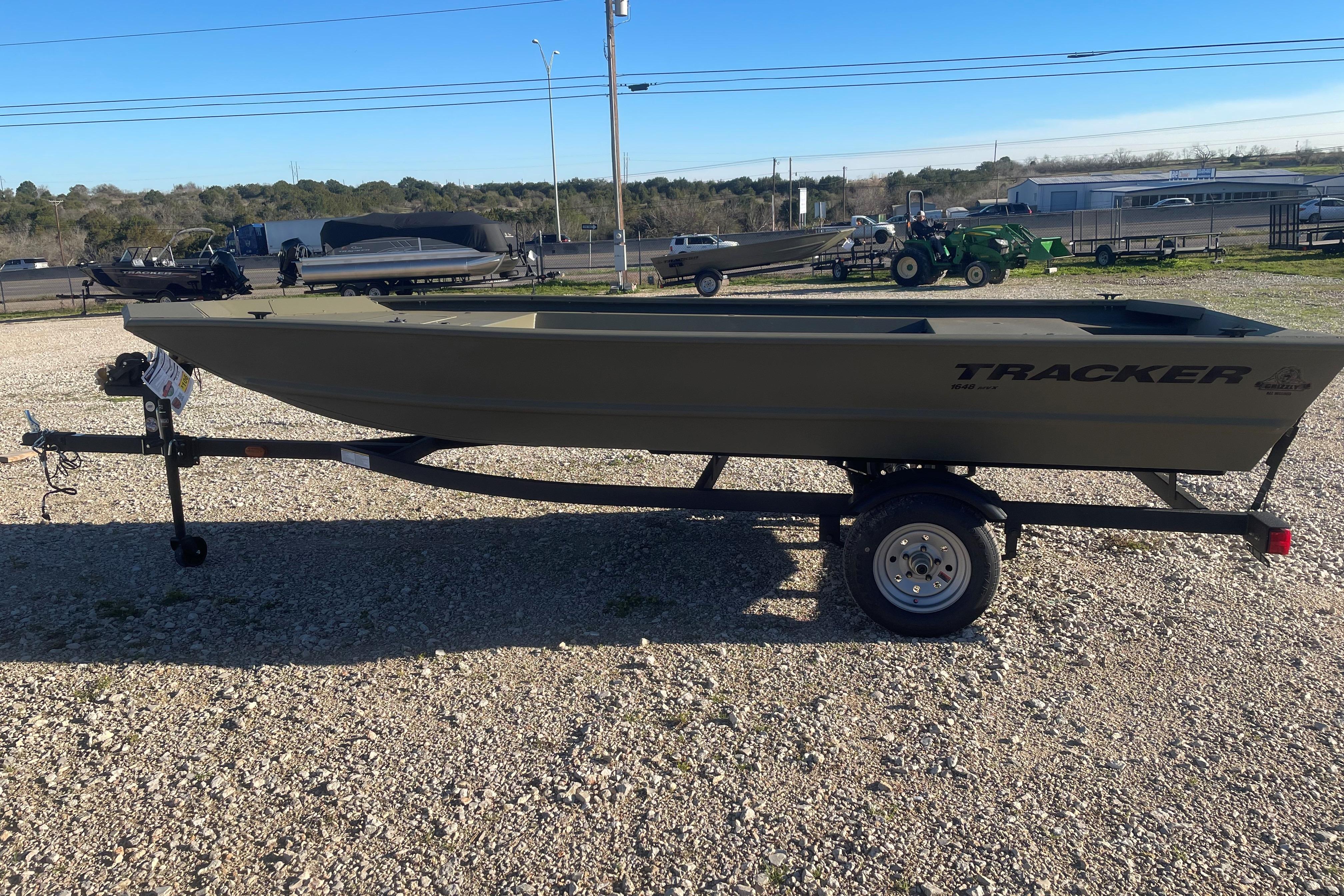 2026 Tracker Grizzly 1648 Utility boat on trailer in outdoor setting.