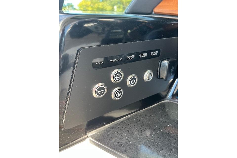 Control panel of 2026 Monterey Elite 27 SD boat with labeled buttons and switches.