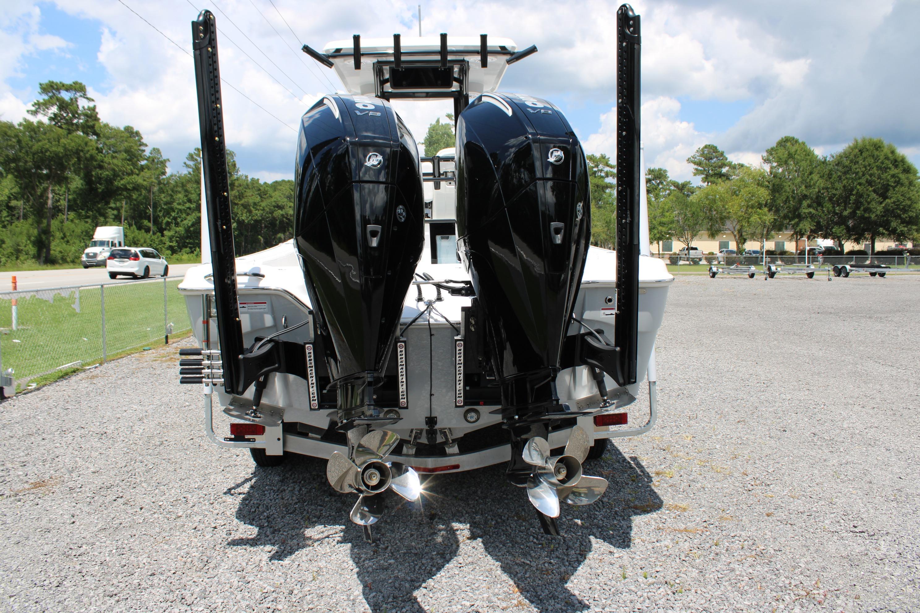2027 Blazer Bay Makaira 2800 with dual outboard motors in a parking lot.