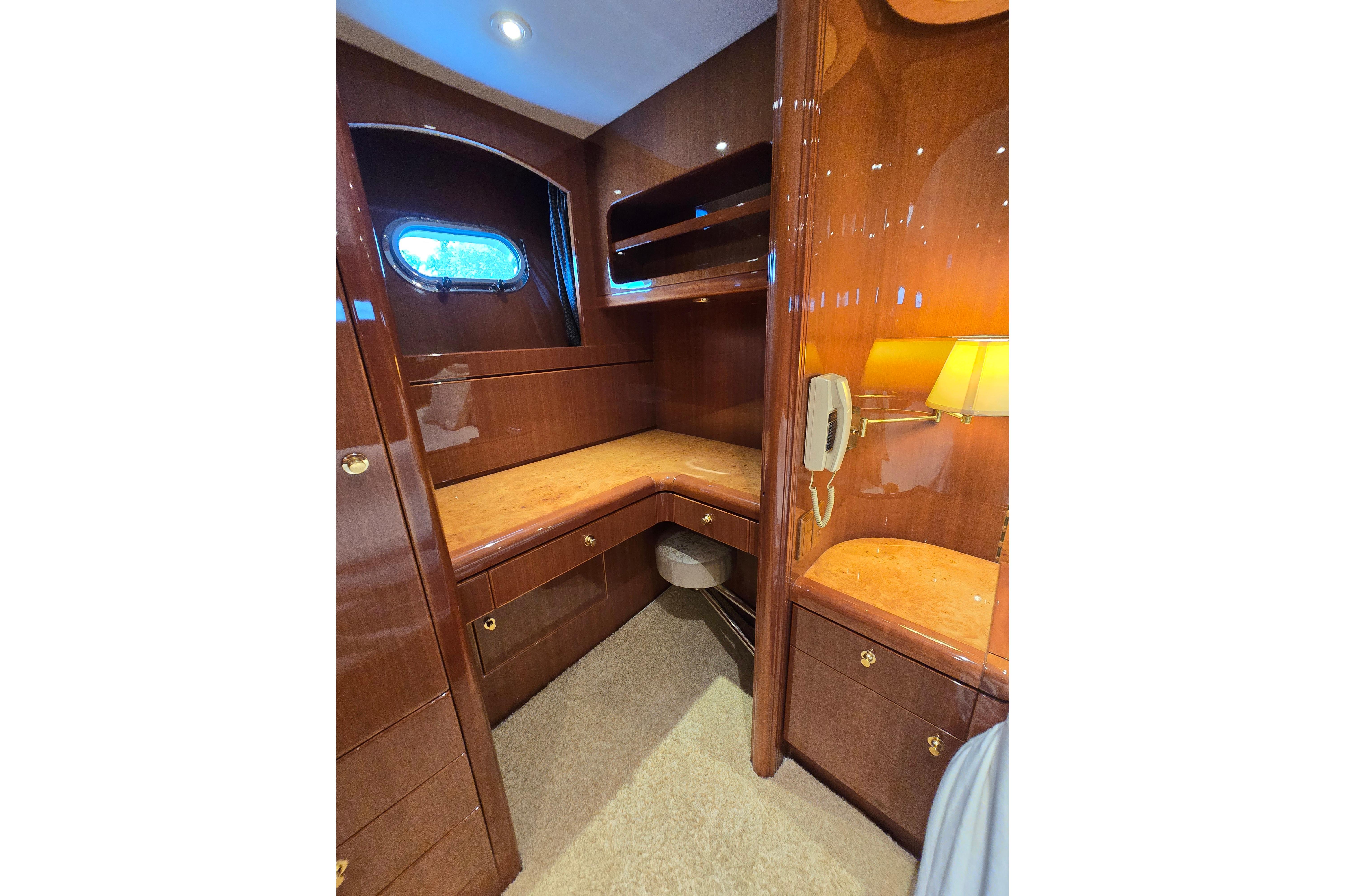 Luxurious wooden interior of a 2004 Grand Harbour 58 yacht with elegant cabinetry and lighting.