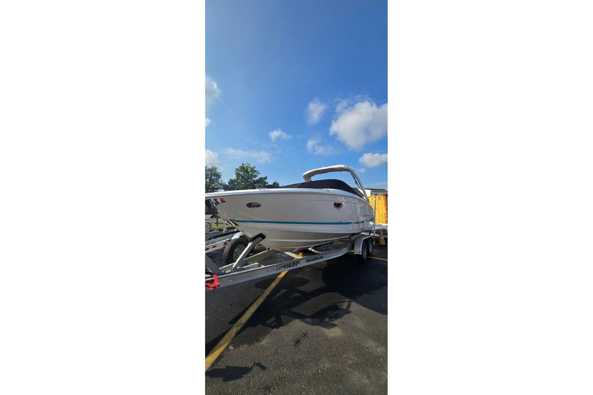 2020 Regal LS6 boat on trailer under clear blue sky.