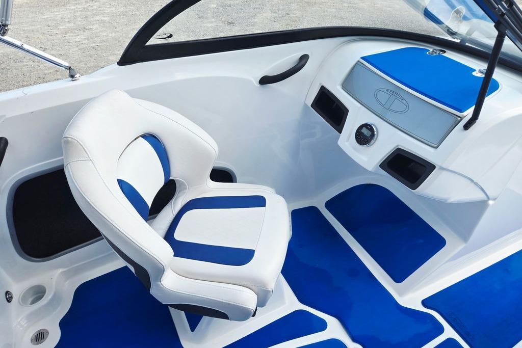 Interior of a 2018 Tahoe 450 TS boat with blue and white seating and dashboard.
