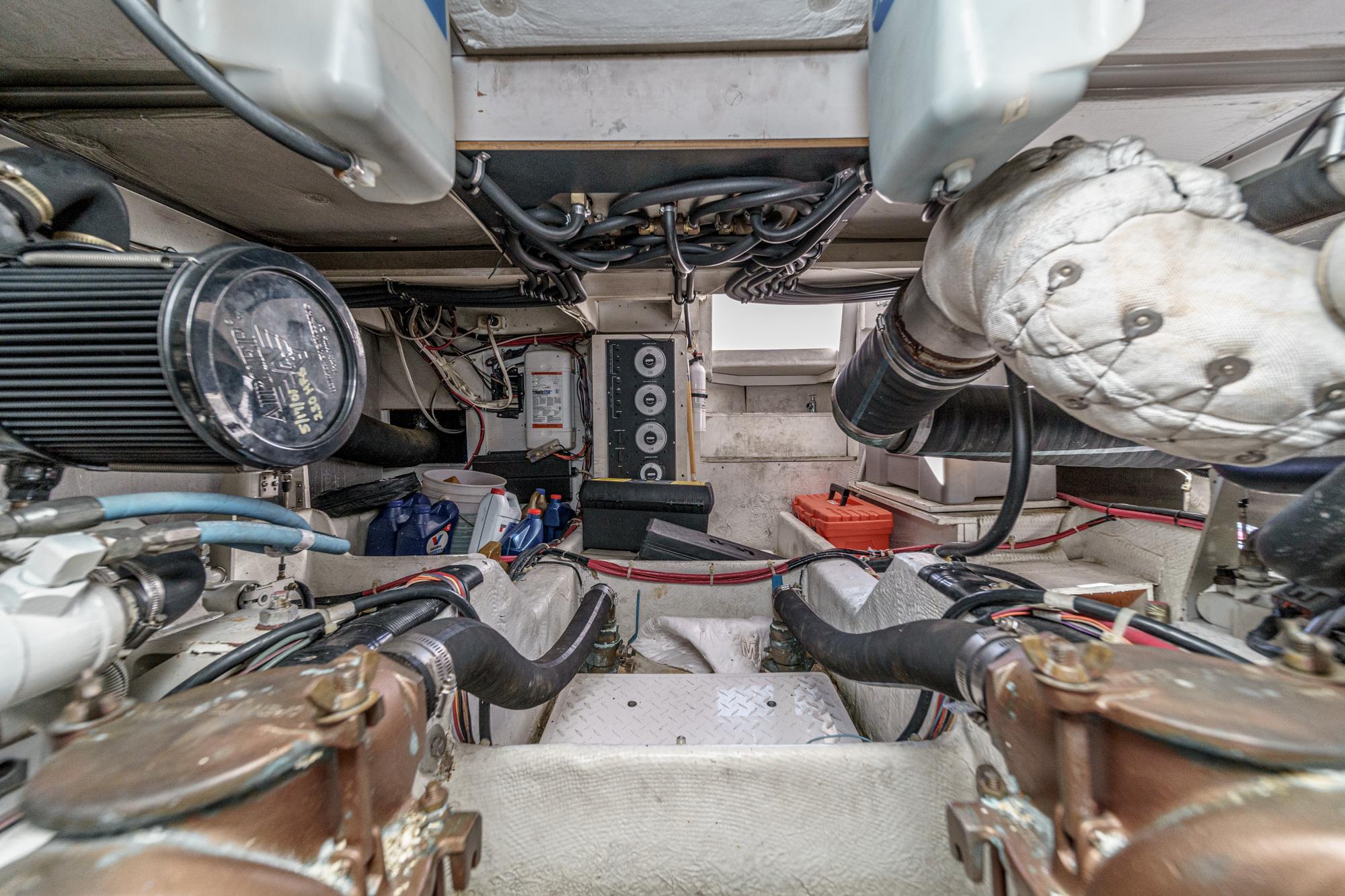 Engine room of 1998 Bayliner 3988 Motoryacht, showcasing mechanical components and wiring.
