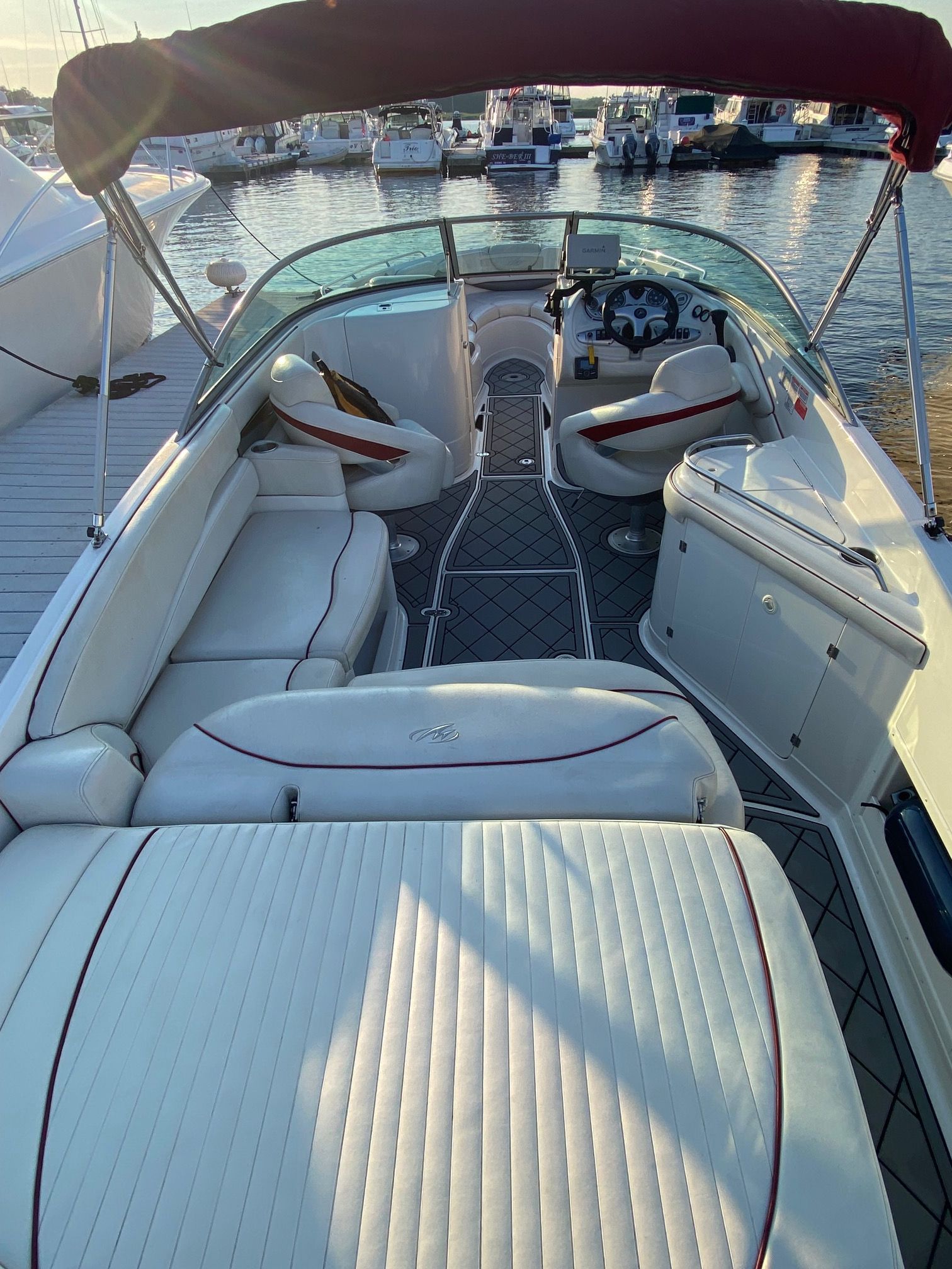 The image shows the cockpit of a 2006 Monterey 268SS Super Sport. It features white upholstery and a red sunshade.