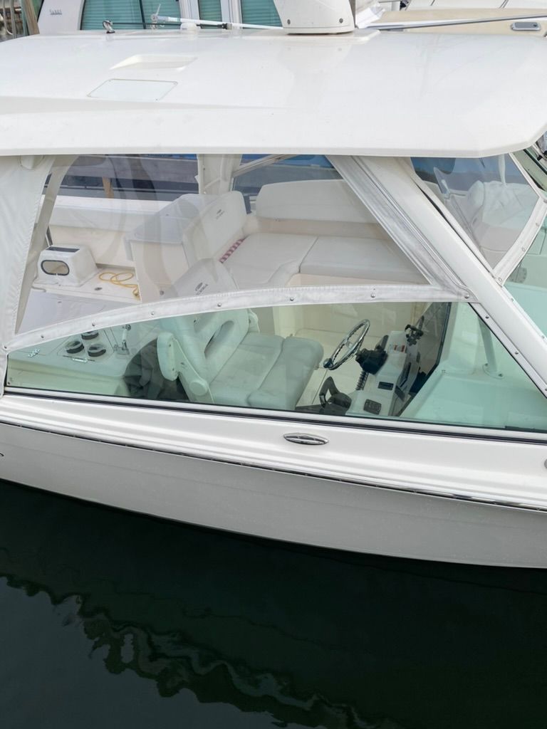 2023 Cobia 330 boat with luxurious interior at the dock.