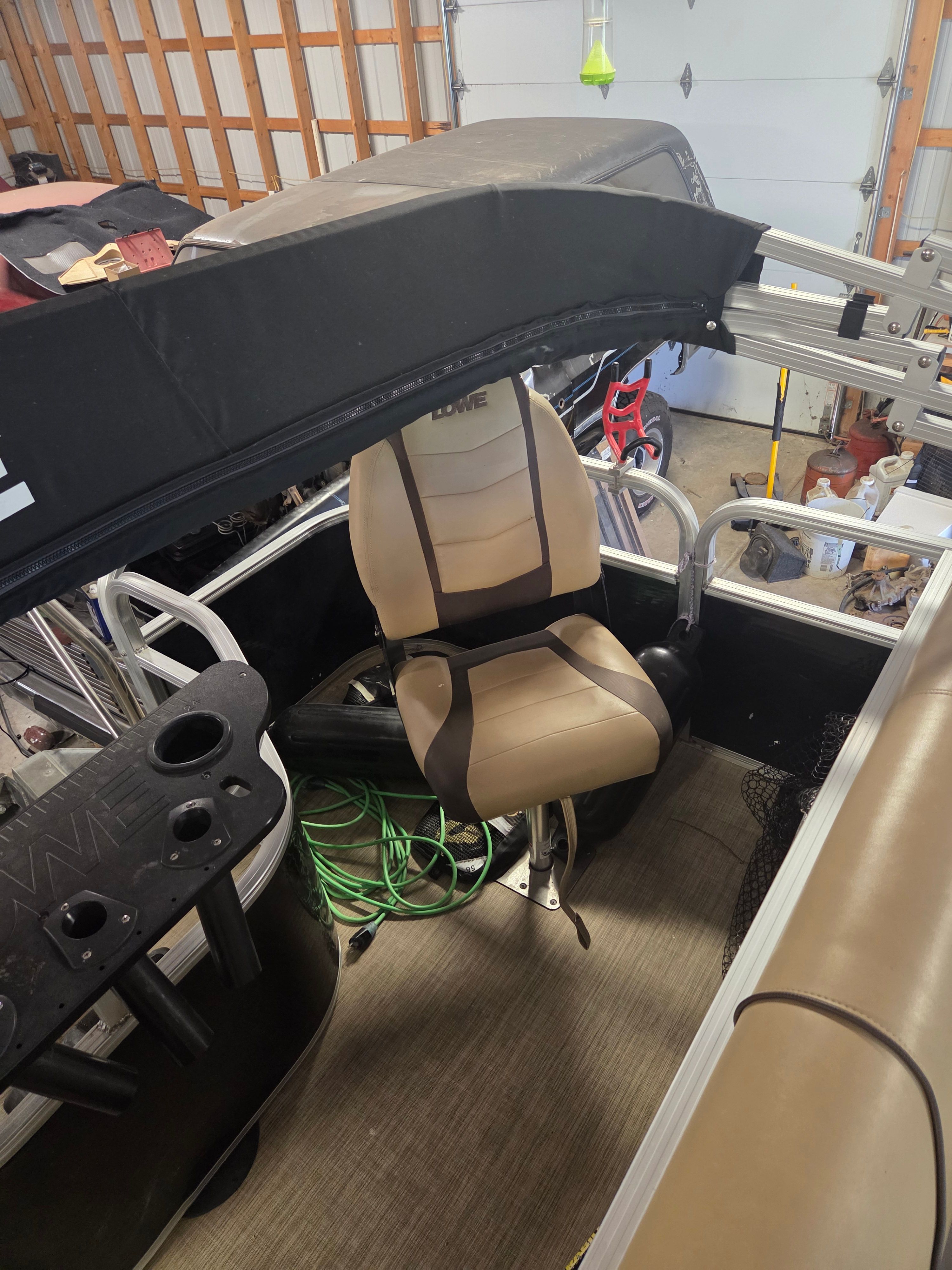 A 2017 Lowe SF 214 Sport Fish boat inside a garage.