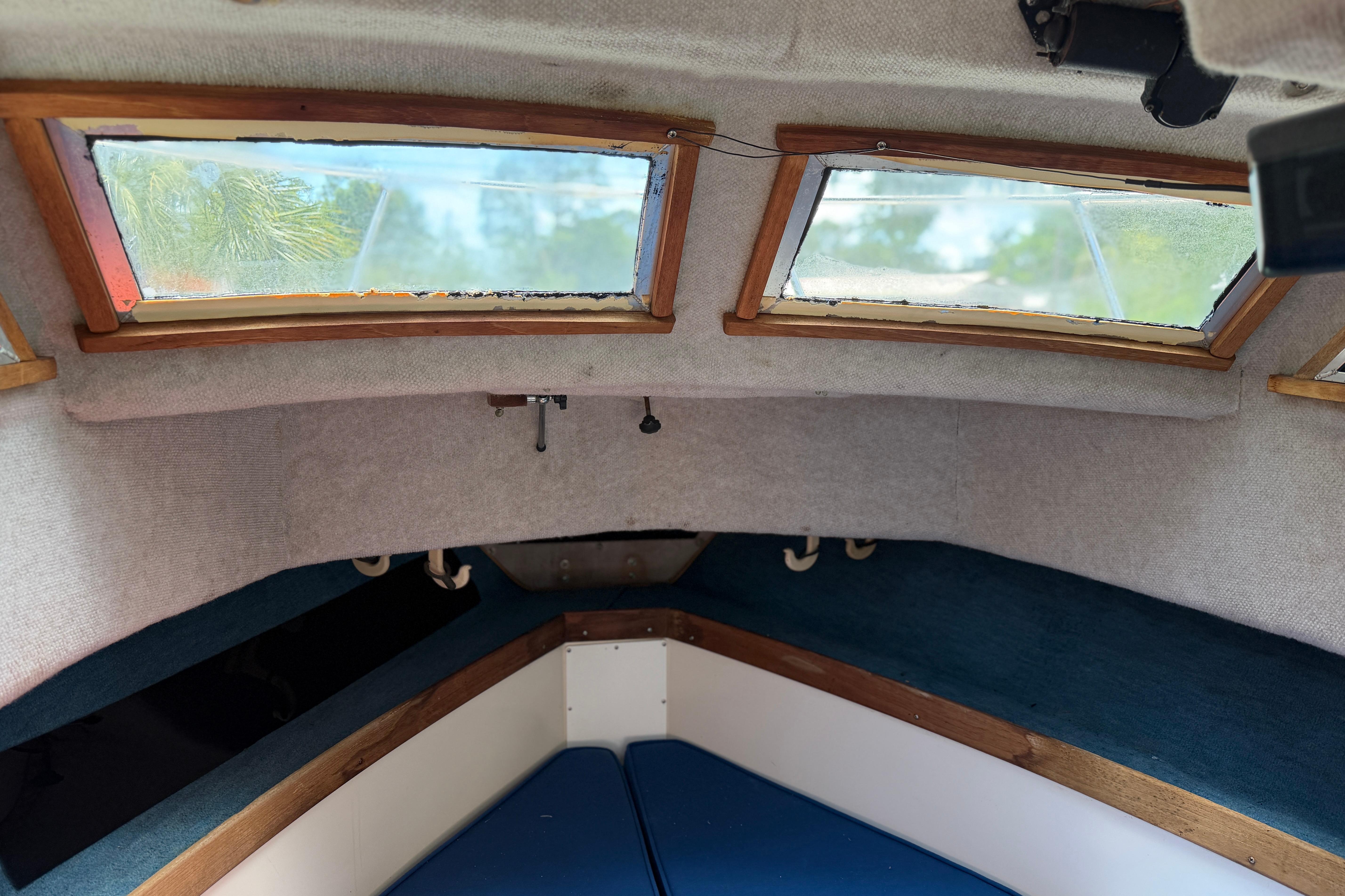 Interior cabin of 1987 Grady-White Seafarer 226 boat with windows and seating.