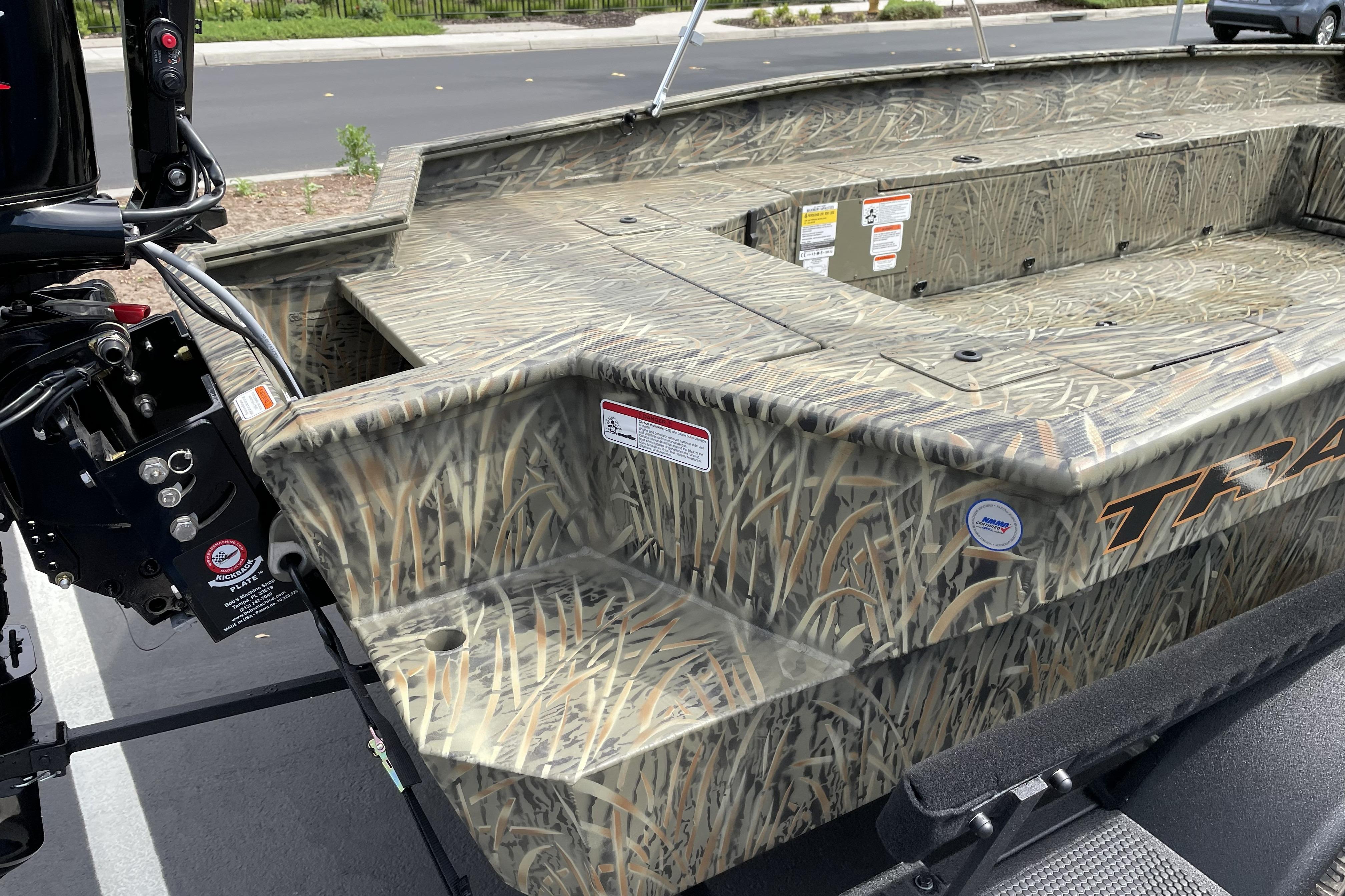 2026 Tracker Grizzly 1756 T Marsh boat with camouflage design, parked outdoors.