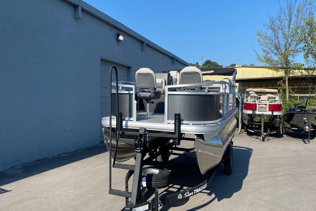 2026 Sun Tracker Bass Buggy 18 DLX pontoon boat on trailer, outdoor display.