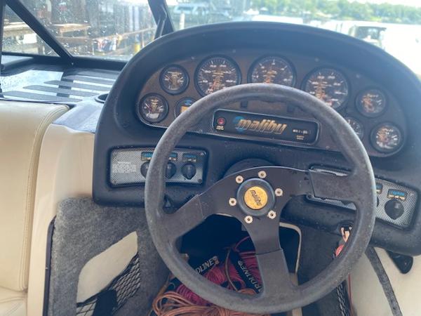 1998 Malibu Response boat dashboard with steering wheel and instrument panel.
