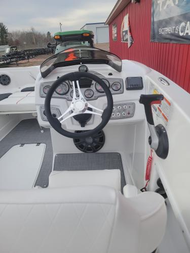 2024 Tahoe 1950 boat dashboard with steering wheel and control panel.