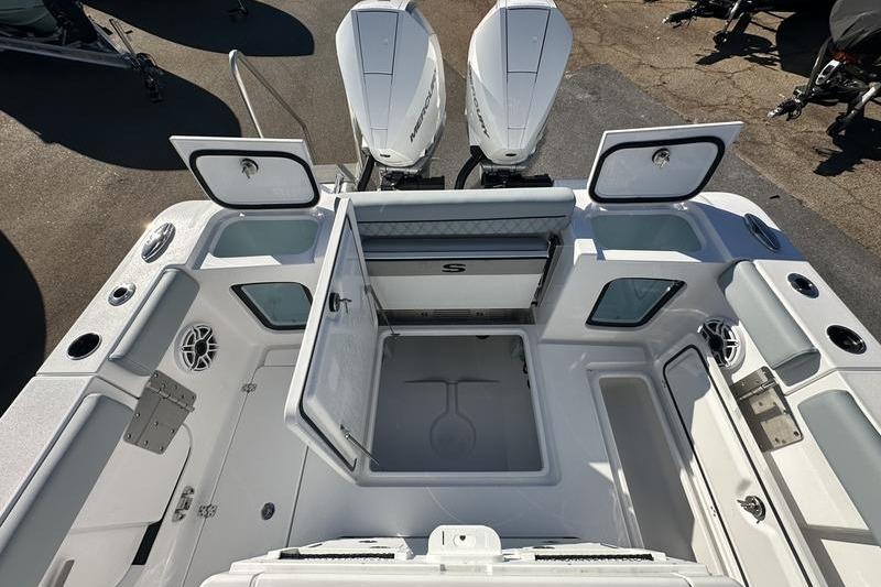 2026 Sportsman Open 282 Center Console boat interior with storage compartments open.