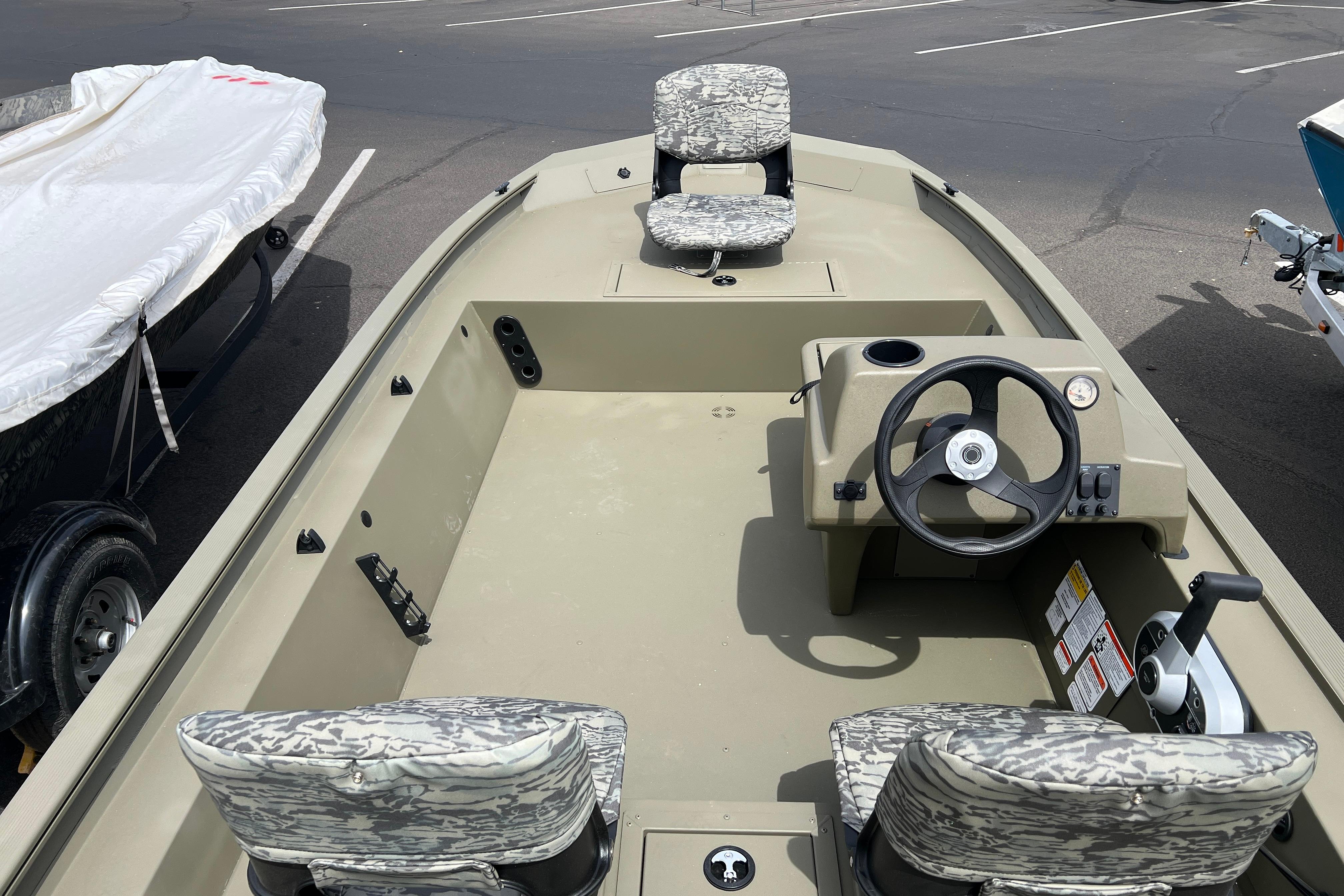 2026 Tracker Grizzly 1754 SC boat with camouflage seats and steering console.