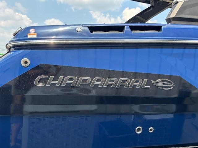 2026 Chaparral SSX 6 boat, blue exterior with logo, under a clear sky.