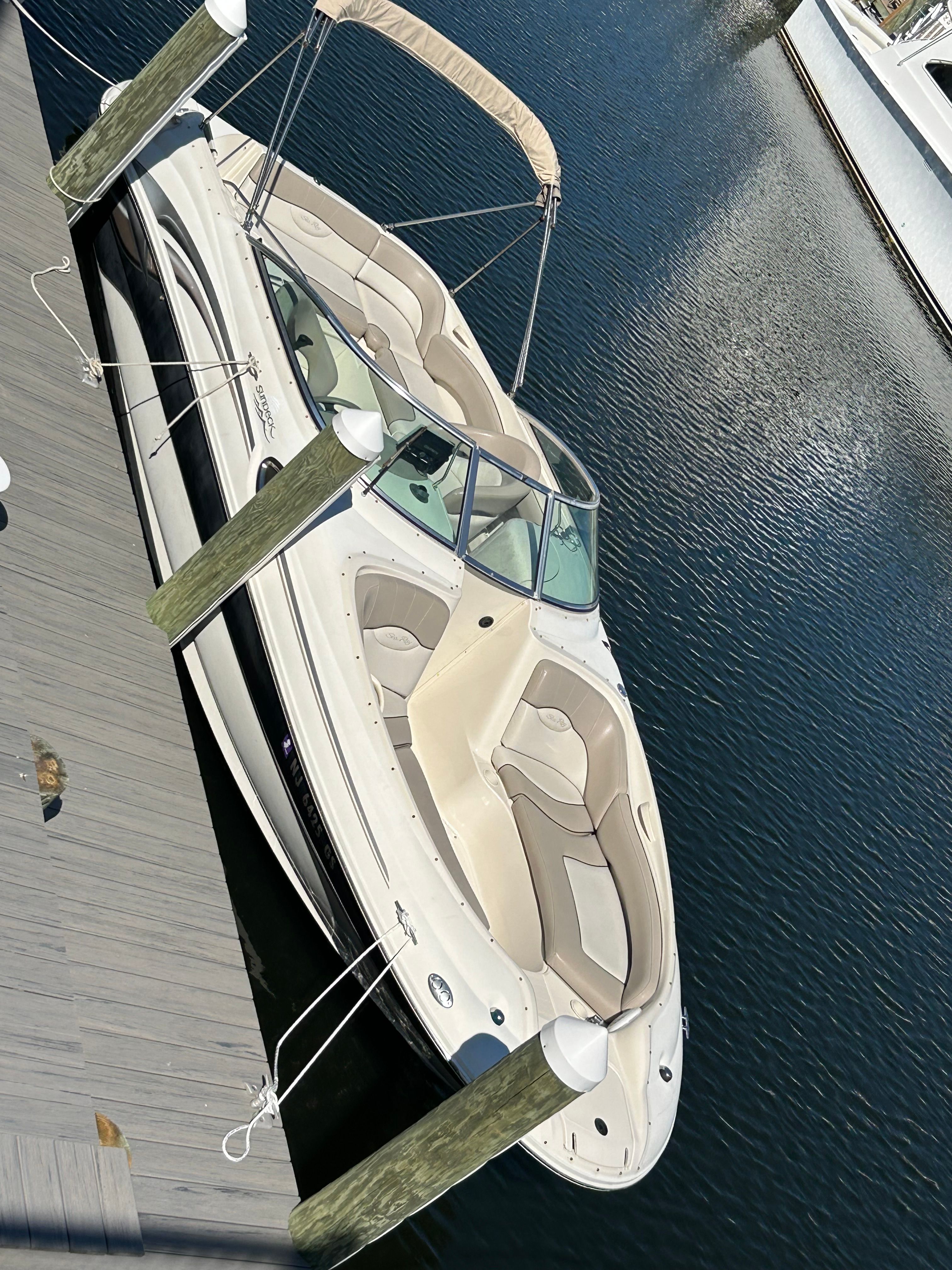 2003 Sea Ray 240 Sundeck docked on calm water.