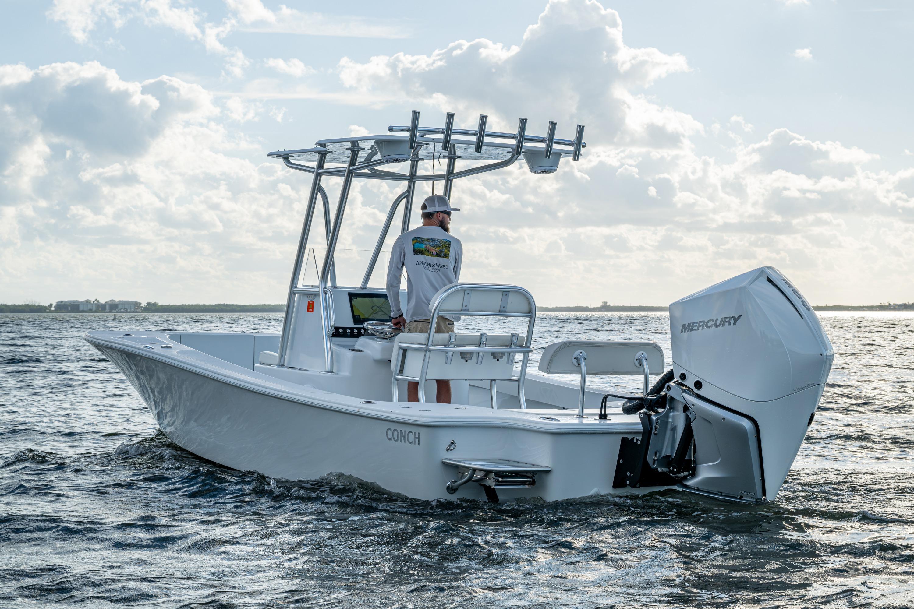 2022 Conch 25 boat on water with Mercury engine, clear sky background.