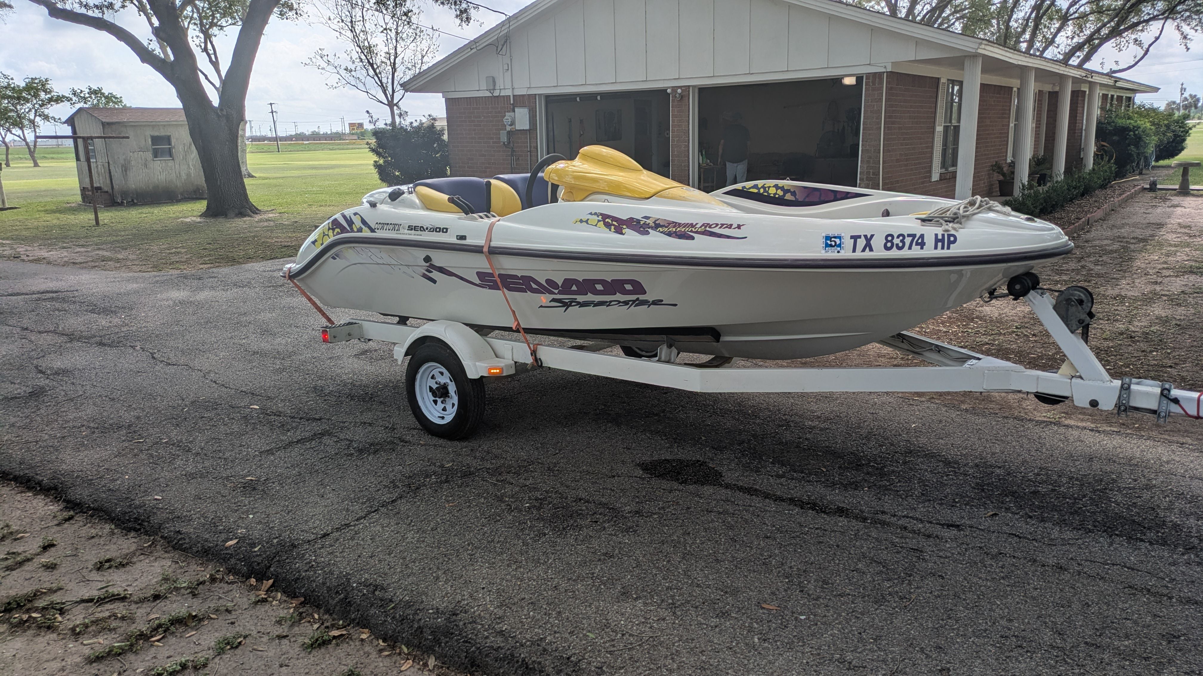 A 1995 Bombardier SeaDoo SPEEDSTER on a trailer, parked on a paved area.