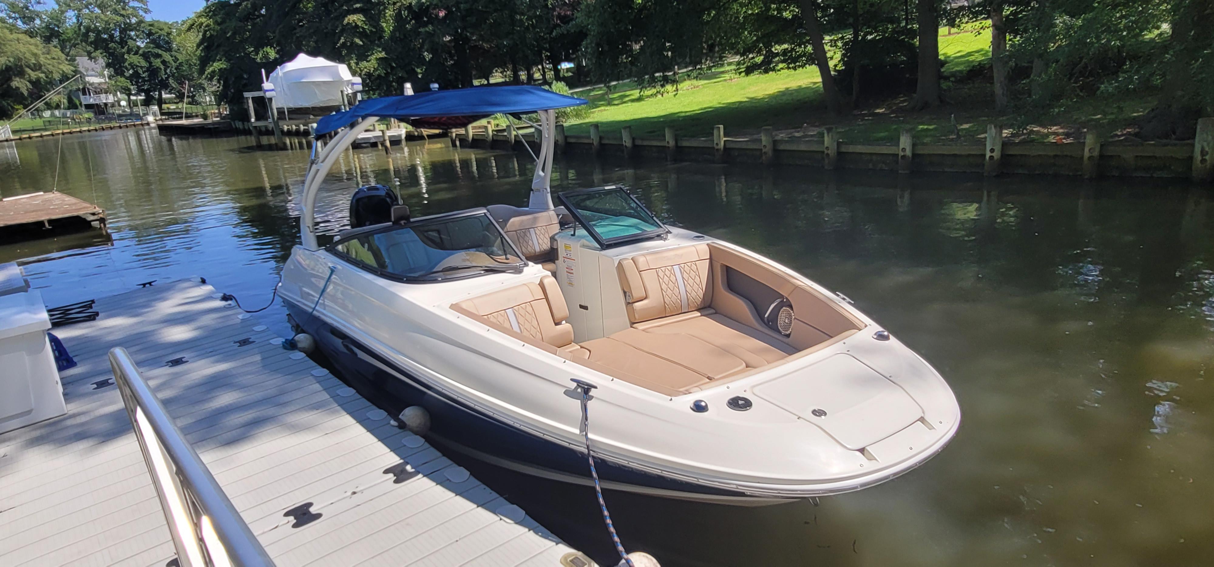 2017 Sea Ray SDX 240 Outboard boat docked on a sunny day.