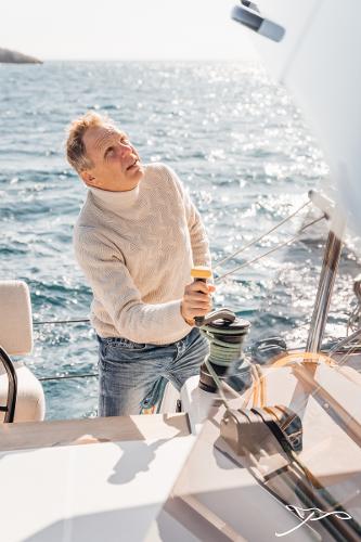 Man sailing Nautitech 44 Open yacht, 2025 model, on sunny ocean day.
