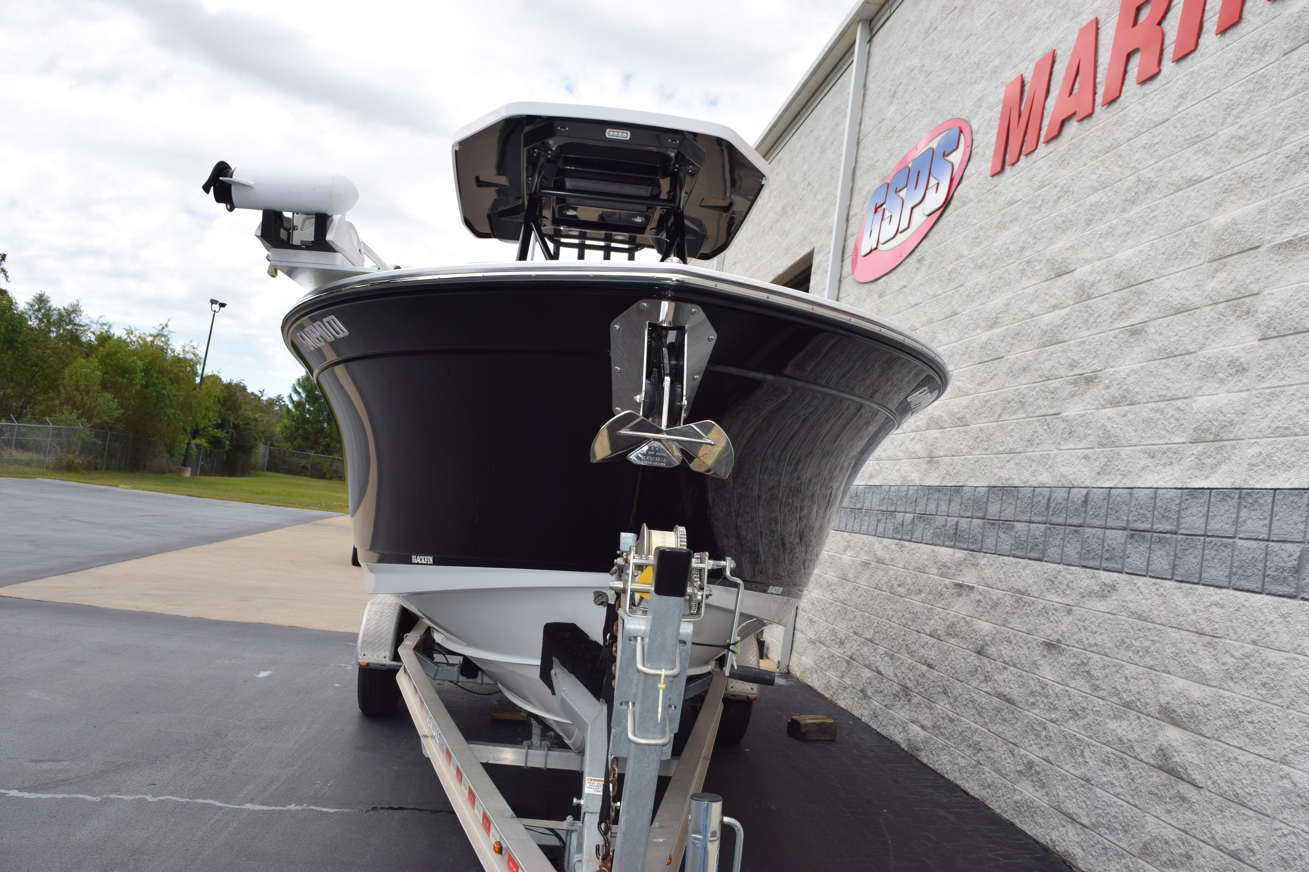 2023 Blackfin 252 CC boat on trailer outside marine dealership.