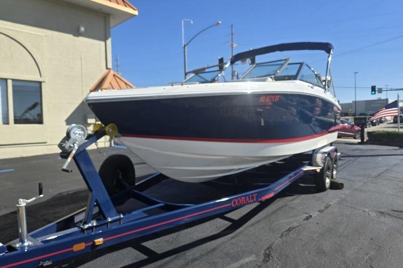 2022 Cobalt R4 boat on trailer in parking lot, sunny day.