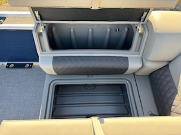 Interior of 2025 Sun Tracker Fishin' Barge 22 DLX with storage compartments.