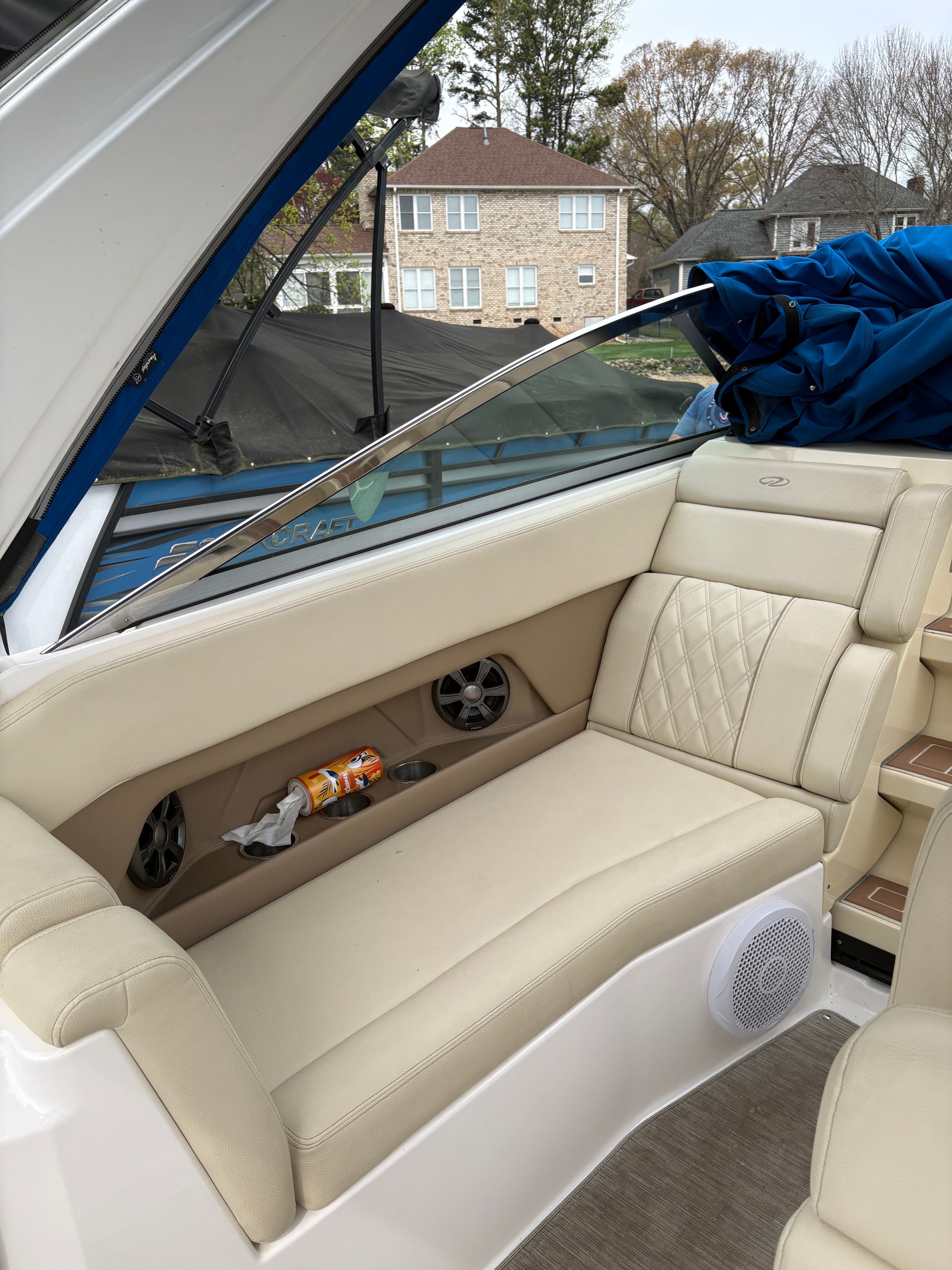 Interior of a 2019 Regal 28 Express boat with beige seating area.