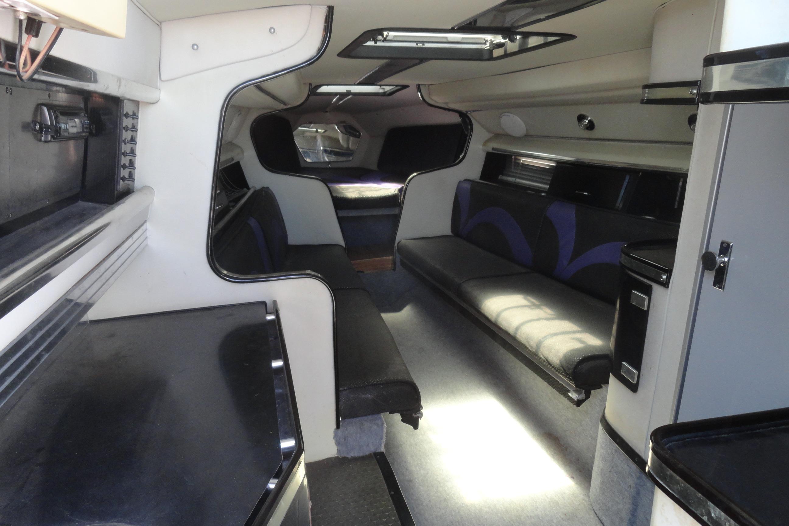 Interior of a 1988 Wellcraft 34 Scarab boat, featuring seating and storage areas.