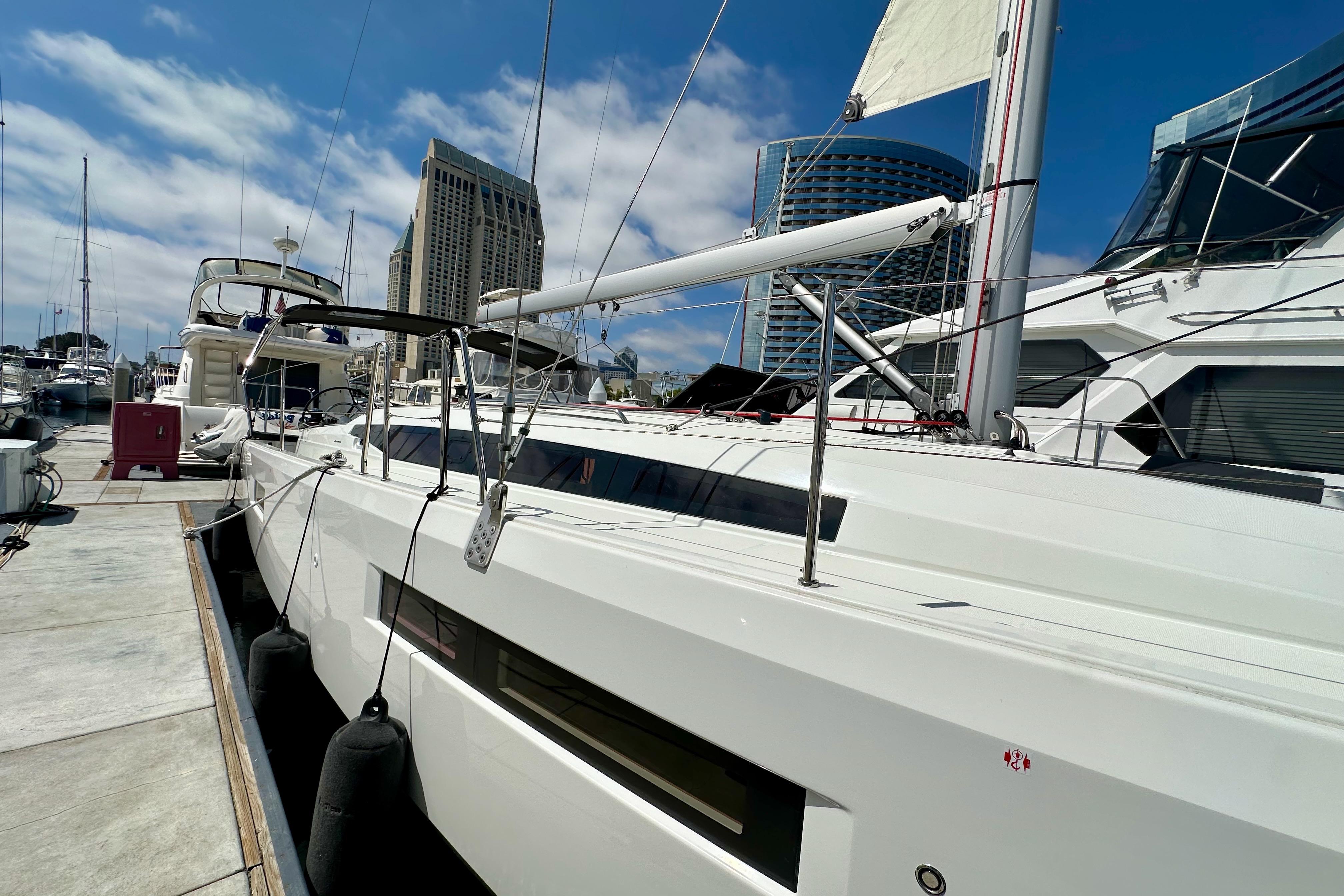 2024 Jeanneau Sun Odyssey 410 yacht docked at marina under blue sky.