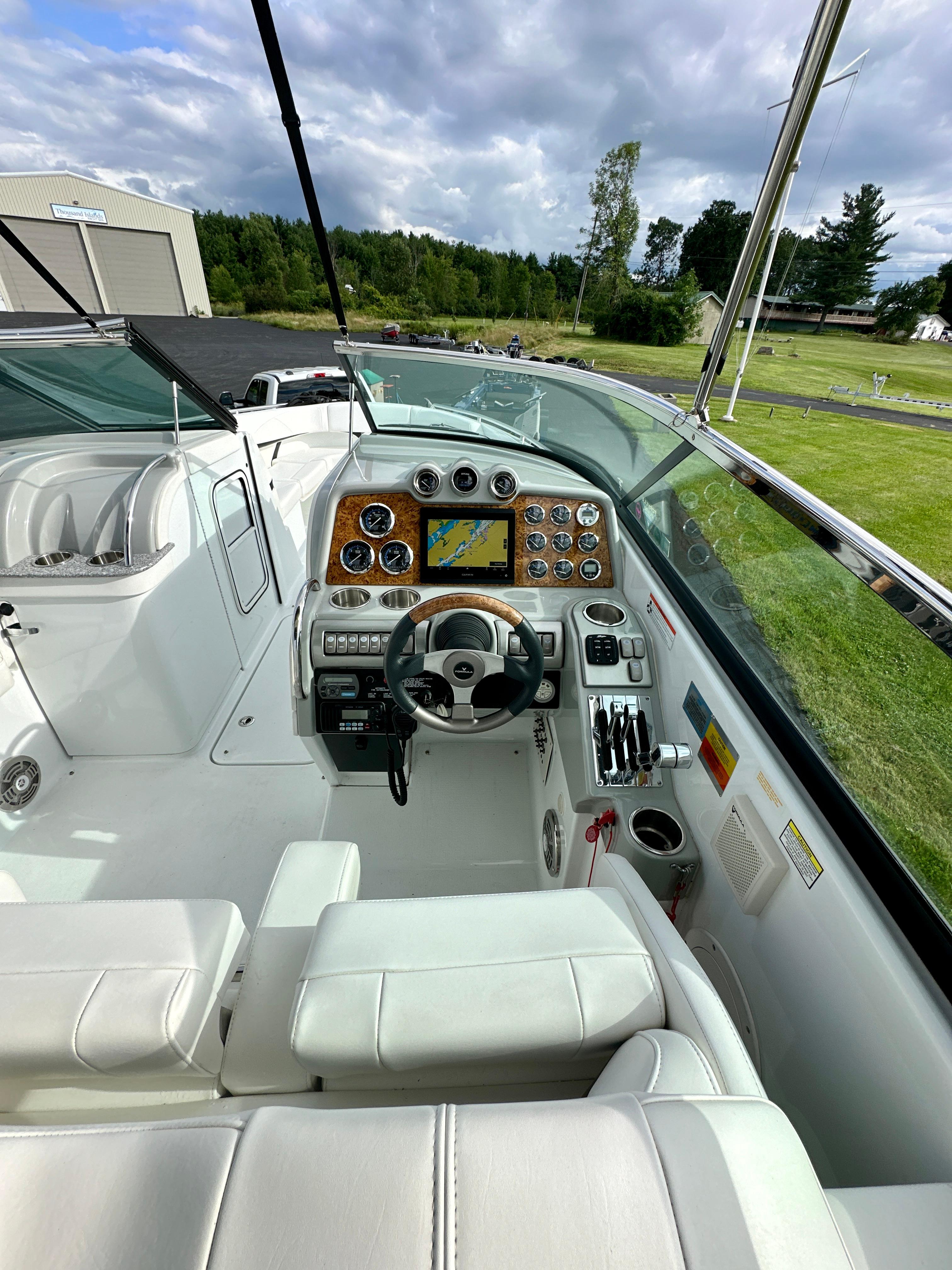 2008 Formula 310 Bowrider cockpit with steering wheel, gauges, and navigation system.