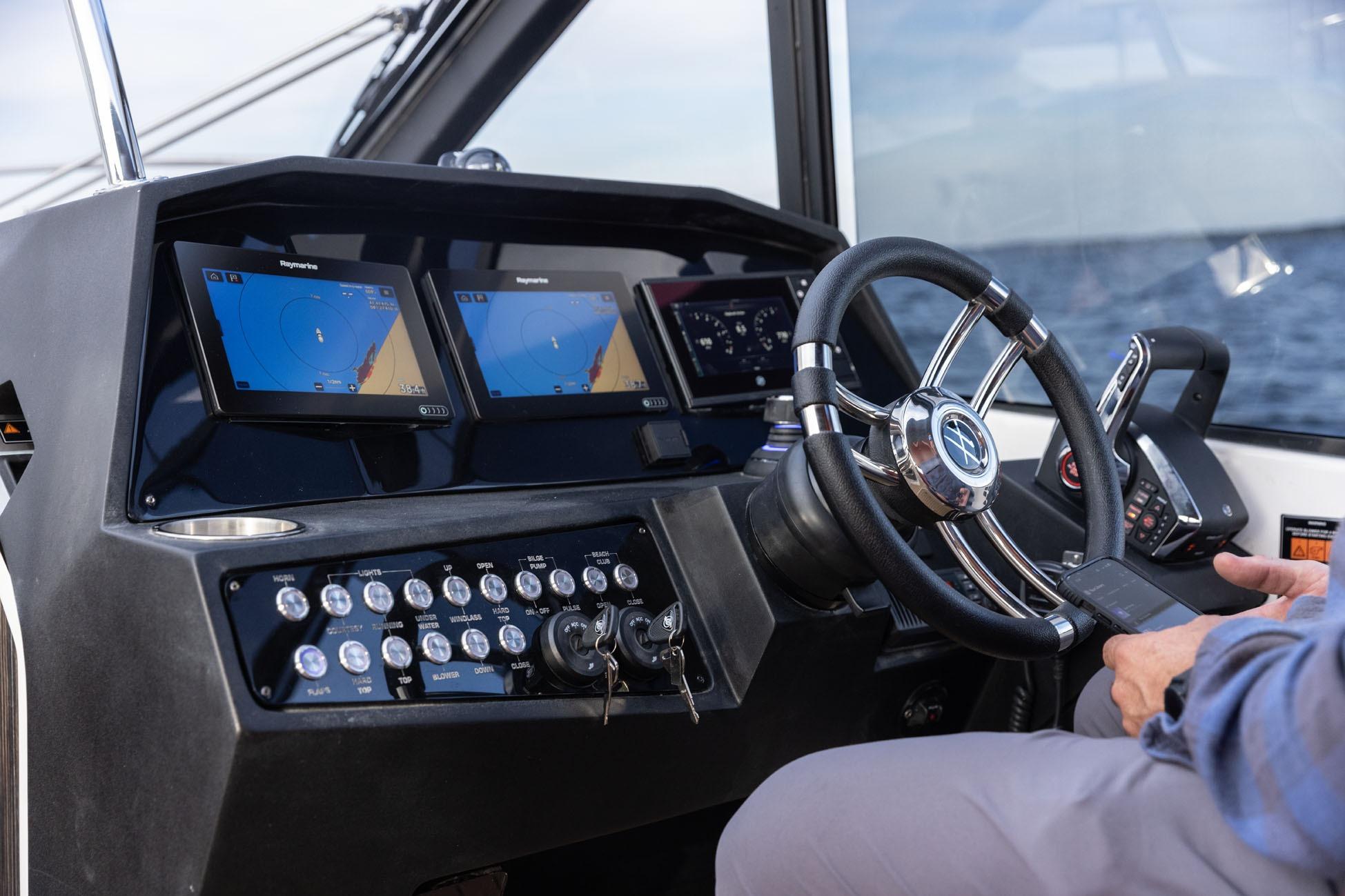 Helm of 2026 Hanover 387 boat with advanced navigation displays and controls.