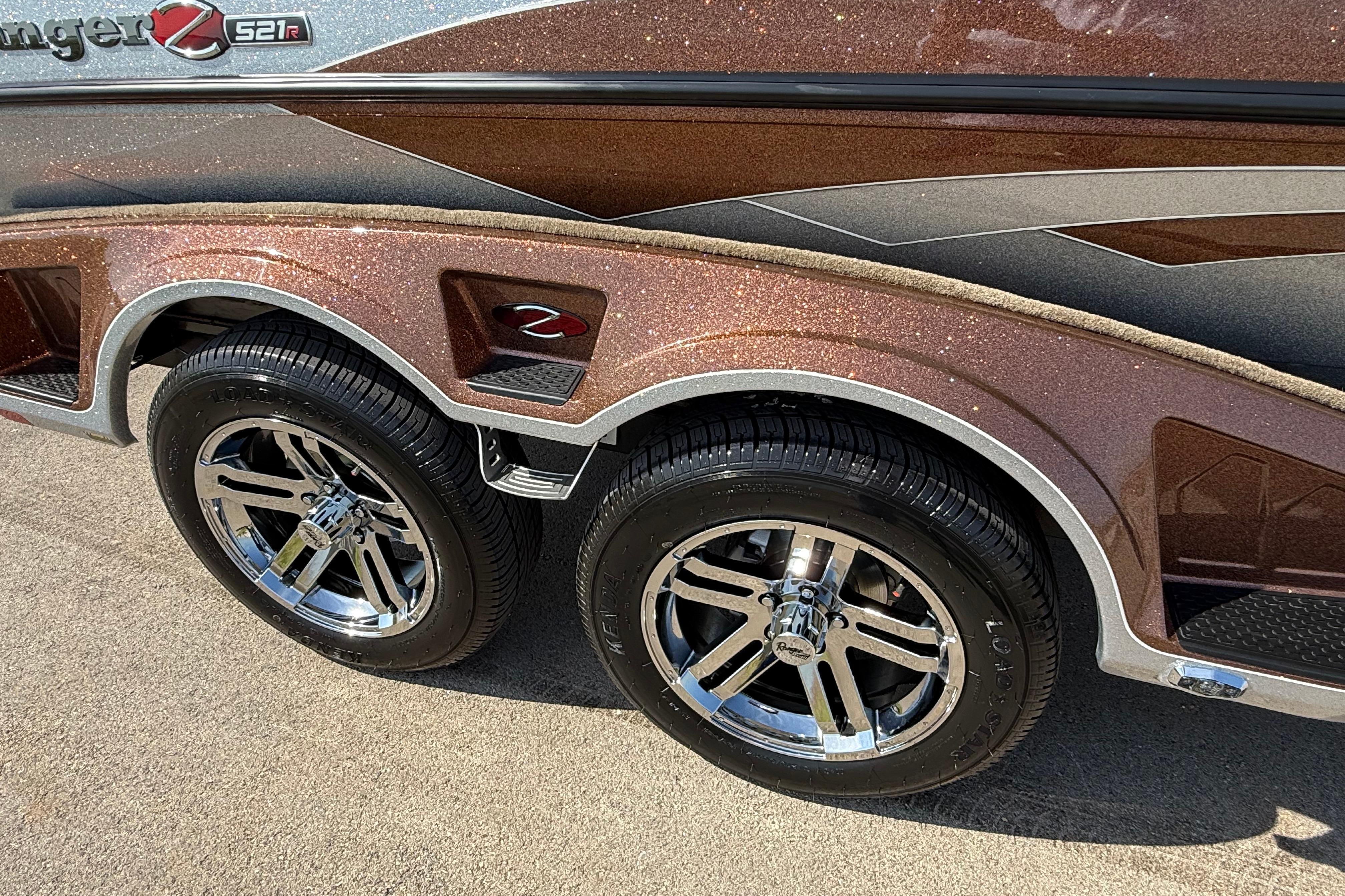 2026 Ranger Z521R boat trailer with shiny chrome wheels and metallic brown finish.