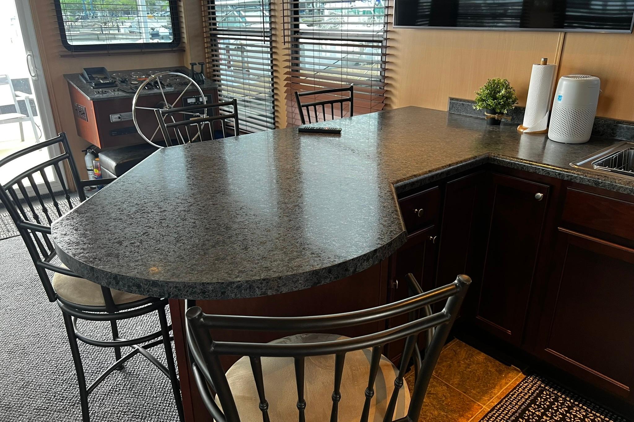Luxurious interior of 2010 Skipperliner 480 Flybridge with modern kitchen and seating area.