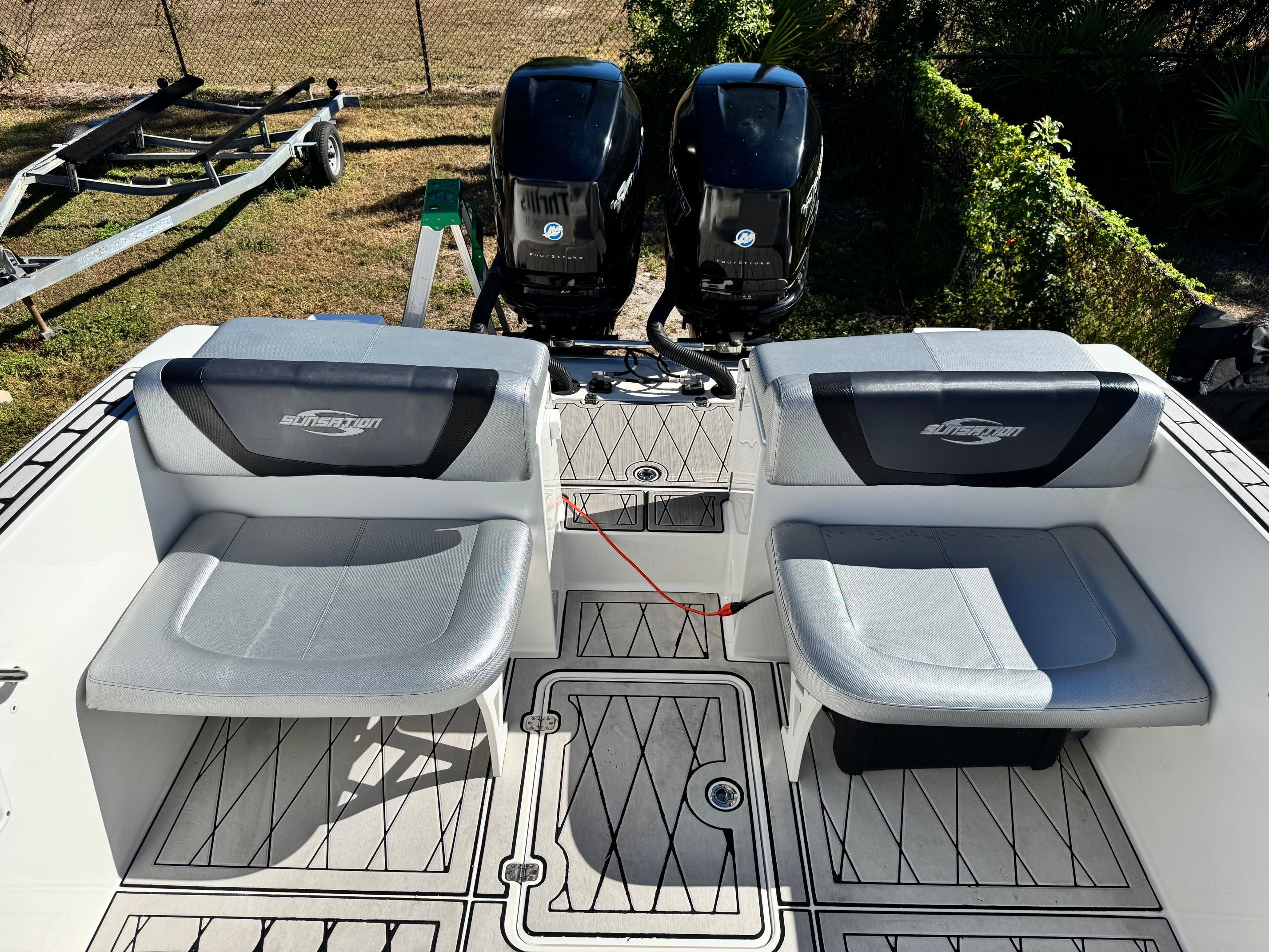 2017 Sunsation 32 CCX boat rear with engines and seating.