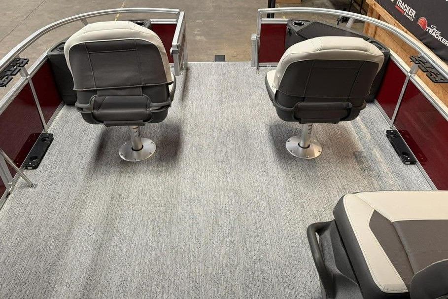 2026 Sun Tracker Bass Buggy 18 DLX interior with swivel seats and carpeted deck.