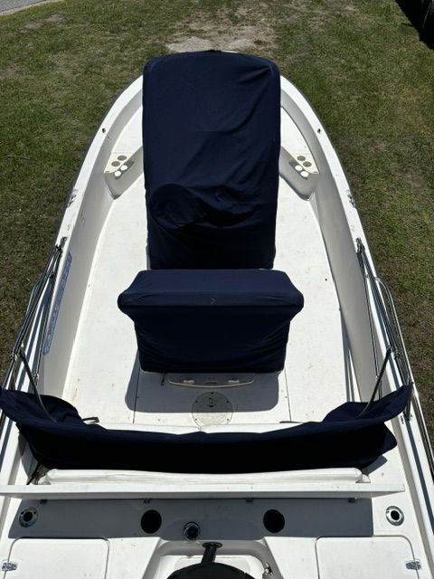 A 2008 Boston Whaler 200 Dauntless with blue covers on the seats.